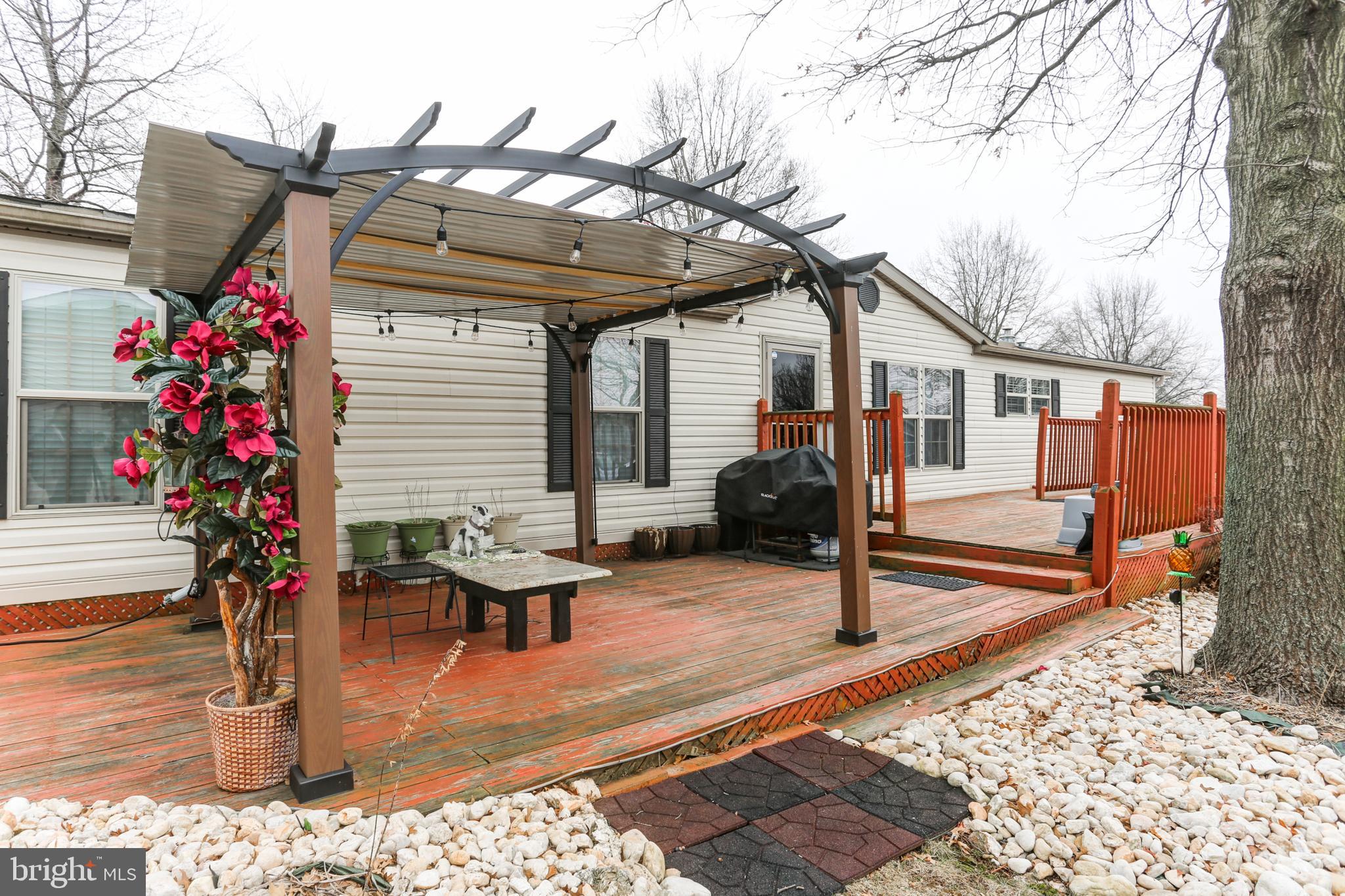This is an excellent opportunity to acquire a beautifully maintained home in a well-managed mobile home community near several parks and campgrounds. The home has 3 bedrooms; 2 full bathrooms, one of which is private to the master suite and includes a dual-vanity, shower, and a hot tub; an open floor plan for the living area; and an eat-in kitchen with an island and a pantry. The home also has plenty of closet space, including a walk-in closet in the master suite, and a laundry room which doubles as a mudroom. Exterior features include a large wrap-around deck, two sheds, beautiful landscaping, and a new, high-capacity A/C compressor (installed in 2019). There are several warranties on upgrades to the home that will convey to the new owner. Schedule a showing today!