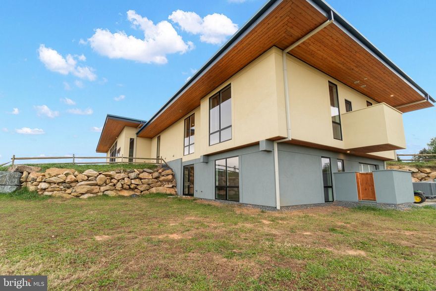 Welcome to this architects dream. Enjoy this modern estate built in 2019 with breathtaking views, a 6 stable barn, and infinity in ground swimming pool. This 97 acre estate features: a lovely 5,500 square foot home designed and built as an architects secondary home for this family with floor to ceiling windows, 30+ foot ceilings in the living rooms, and hardwood flooring throughout.  Built with views in mind, you can prepare dinner while overlooking the mountainous terrain and stocked pond.   The home has endless parking with the wrap around driveway and a 2 car covered garage for your most prized possessions.   4 Bedrooms/ 4.5 Bathrooms and a fully finished basement leaves endless space for you to enjoy with all bedrooms having 11+ ft ceilings.   For the summer months, enjoy the infinity pool.  Enjoy a cup of coffee and watch the sun rise in the East or a romantic dinner while enjoying the sunset in the West on the wrap around porch that can see every angle.   The brand new  barn has 6 Horse stables, a riding ring, , and the potential for another apartment to be added on top.  The land also includes a 1 bedroom/ 1 bathroom cabin that can be used as a guest house.  The land is primarily pastures and hayfields for your horses and animals to roam freely, being partially fenced for their safety.  Mill Run stream runs through the property ideal for fishing or strolling along the riverbank.  Don't miss the opportunity to own this beautiful piece of property, the opportunities are endless.  Please contact us if you'd like a virtual  walk through tour.