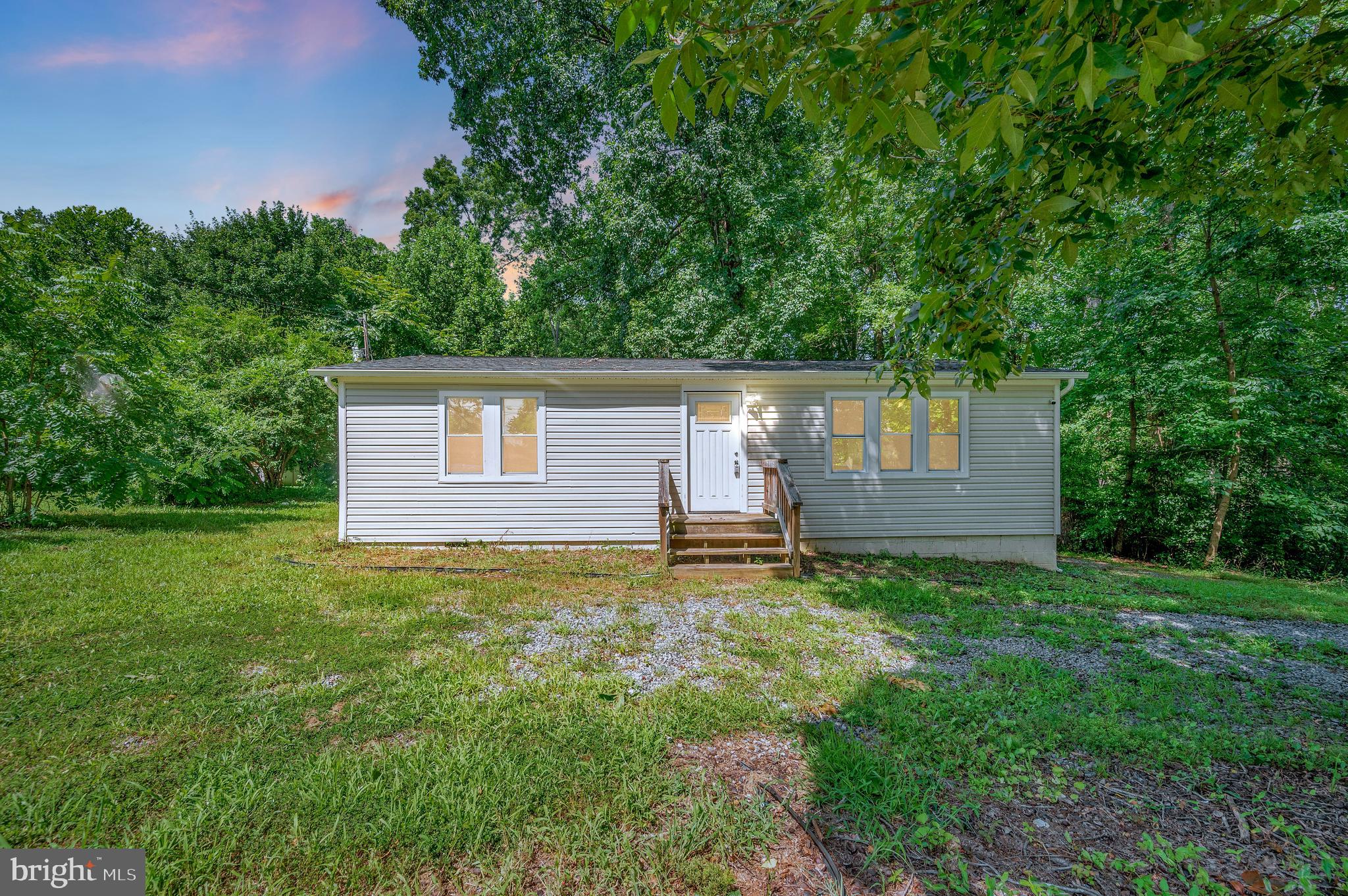 Welcome to this cute 2-bedroom, 2-bath home situated on nearly half an acre with a beautiful tree-lined backdrop. Enjoy the spacious and level backyard—perfect for outdoor activities and relaxation—with a deck just off the back of the home, ideal for entertaining or unwinding. Inside, you'll find a number of upgrades including granite countertops and tastefully updated tile bathrooms. Whether you're looking for your first home, downsizing, or seeking a peaceful retreat, this property offers great potential. Bank owned home being sold as is.