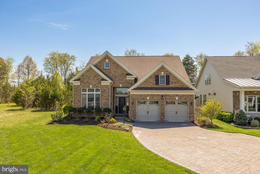 Rare opportunity to own one of the most distinctive homes in Regency at Creekside, situated on a double corner lot bordering protected open space the community will never develop. With over 3,500 square feet, more than $75,000 in seller upgrades, and an interior finish well beyond a typical new build, 6202 Chancellorsville Dr delivers a lifestyle that is genuinely hard to replicate.

Step through the front porch into a dramatic two-story foyer with a soaring 15-foot ceiling and full oak staircase. The open main level features 10-foot ceilings, crown molding, custom ceiling treatments, and designer wall paneling throughout. A double-sided fireplace clad in floor-to-ceiling stacked stone anchors the living room while opening directly to the patio, so the warmth carries seamlessly from inside to out. A private office enclosed by custom French doors, with an ornate custom ceiling treatment and designer paneling, rounds out an impressive main floor.

The primary suite is in a category of its own. Extended 10 feet beyond the standard footprint, it flows into an oversized sitting room that overlooks the backyard through French doors to the patio. Designer wall paneling, tray ceiling detailing, and crown molding create a hotel-like ambiance. The en-suite bath features dual vanity, quartz countertops, and a walk-in glass shower with floor-to-ceiling tile. The custom walk-in closet is a true luxury build-out with integrated LED lighting, a 160-pair motorized shoe carousel, a velvet-lined jewelry organizer, and a built-in laundry chute. A second bedroom and full bath on the main level are ideal for guests. The second floor opens to a bright, expansive loft suited as a media room or recreation space, alongside a third bedroom, full bath, and utility area. A large attic provides exceptional storage capacity rarely found in the community.

Out back, a premium Techo-Bloc multi-level patio with elegant stonework wraps the rear of the home, and the indoor/outdoor fireplace extends the entertaining season into cooler months. French doors from both the primary suite and living area open directly onto the patio. Out front, the corner position yields an approximately 60-foot driveway with a 4-foot turnaround. The garage is extended 4 feet beyond the standard footprint and includes an EV charging port, a side door, and automated Trimlight holiday lighting. Regency at Creekside offers resort-style amenities including a clubhouse, pickleball and tennis courts, indoor and outdoor pools, paved walking paths, and a fishing pond. The HOA covers snow removal for driveways and sidewalks. Conveniently located near Harris Teeter, Aldi, Walmart, and Target, with easy access to I-66 and multiple nearby parks.