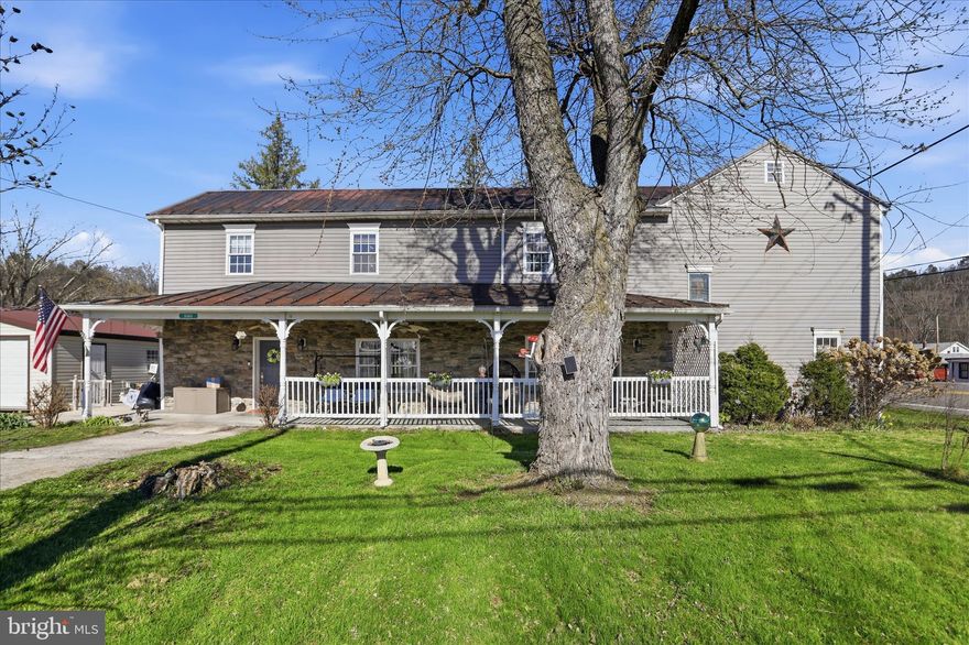 Step back in time while enjoying modern comforts in this stunning colonial-style home, originally built in 1837 and rich with character and charm, located in Springfield, WV in Hampshire County. From the moment you arrive, you’ll be captivated by the impressive stone front and expansive covered front porch—perfect for relaxing mornings or unwinding evenings.

Inside, the main level offers a spacious and functional layout featuring a large, separate dining room, a welcoming family room, and separate living room. A beautifully appointed kitchen complete with dark cabinetry, laminate countertops, and stainless steel appliances. The double oven and electric cooktop are already equipped with a gas hookup option, offering flexibility for your cooking preferences. A convenient laundry room is also located on the main level.

This home provides the ease of main-level living with a generously sized bedroom with double closets, a full bathroom featuring a walk in shower, along with an additional half bath off the laundry room. Throughout the home, you’ll find gorgeous wood trim and timeless details that highlight its historic roots, paired seamlessly with thoughtful updates. Multiple stone fireplaces add warmth and character throughout the home. While they are not currently in use, they can be connected to the existing gas line, offering potential for future enjoyment. A propane tank is already in place and simply needs to be filled.

The current owners have invested in significant upgrades to enhance both comfort and functionality, including a brand new HVAC system, a 24' x 24' garage from Shawnee Structures, and an HAU septic system (mound) installation—offering peace of mind for years to come.

Upstairs, you’ll discover a versatile and expansive space—perfect for a child’s dream gaming room, media room, or large entertainment area—along with three additional bedrooms and a  two full bathrooms, providing plenty of room for family and guests. In addition, there is also a home office, perfect for working from home!

Step outside to enjoy a spacious backyard retreat featuring a large patio, private deck with French doors leading from the main level bedroom, and a charming wrap-around sidewalk, ideal for entertaining or simply enjoying the outdoors.

Whether you’re looking for a spacious primary residence or exploring revenue-generating possibilities, this property offers incredible flexibility. With its size, layout, and charm, it has excellent potential as a large family home, an Airbnb, small business, or other uses—giving you the freedom to make it your own.

This one-of-a-kind property beautifully blends historic elegance with modern updates—don’t miss your chance to own a truly special home!