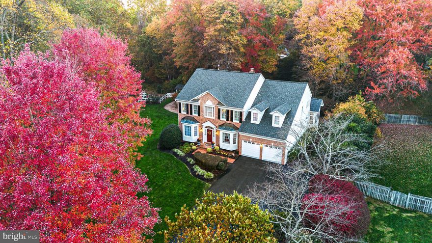 Welcome to the best lot in Stoney Creek Woods. Set on .63 acres and backing to over three acres of protected, unbuildable parkland, this home offers unmatched privacy and peaceful, nature-filled views—all within the sought-after Langley High School Pyramid.

Inside, you'll find 5 bedrooms, 4.5 bathrooms, and multiple living and entertaining spaces. Upon entry, you're welcomed by a two-story foyer featuring wainscoting, chair rail molding, and recently installed wide plank hardwood floors that continue throughout the main level and upstairs foyer. A formal dining room and living room with bay windows are located at the front of the home, while a main-level office with custom built-ins offers quiet workspace and looks out to the backyard. The heart of the home is the kitchen—featuring Wolf appliances, a Sub-Zero refrigerator, LG dishwasher, stone backsplash, and a generous island. A butler’s pantry with built-ins adds both charm and storage. Columns frame the entrance to the sunroom, which is bathed in natural light from a grand Palladian window and overlooks the serene, tree-lined backyard. Just off the kitchen, the family room features a floor-to-ceiling stone fireplace and two sets of French doors that open to the deck for effortless indoor-outdoor living.

Upstairs, the primary suite includes a sitting area, a large en suite bath with a soaking tub, glass-enclosed shower, and dual vanity. There’s a generous walk-in closet, an additional cedar closet, and a laundry area conveniently located just off the closets, offering both space and function. The finished walkout basement features a gas fireplace, a guest suite with a sitting room, a dedicated movie room, a custom wine cellar, and additional space for entertaining or relaxing.

Recent updates include a new roof (2023), new driveway (2024), Marvin windows throughout, and a Rachio smart underground irrigation system. Outside, the backyard is truly special—quiet, expansive, and private. With no homes behind you and protected parkland as your backdrop, you’ll enjoy a rare sense of seclusion. A stand-alone outdoor shed and fenced-in gardening area complete this serene space, offering practical storage and room to grow. Whether you're entertaining on the rebuilt deck, enjoying quiet mornings surrounded by trees, or letting pets roam in the fenced yard, this outdoor space is designed for both peace and play.
