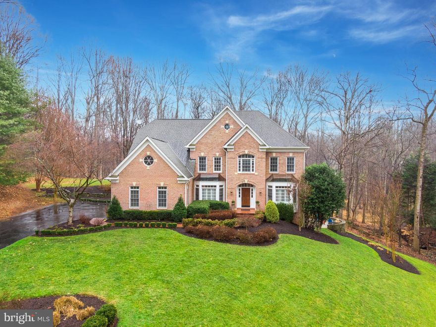 Welcome home to this exquisite Great Falls dream home, located on a private wooded lot of almost 2 acres! Langley High School pyramid. With over 5,900 finished square feet of immaculate living space, this property offers a plethora of outstanding features including hardwood floors throughout the main and upper living areas; elegant mouldings throughout; 9' ceilings on main and lower level with vaulted ceilings in select rooms throughout; plantation shutters in the main level and Primary Suite; a two story Foyer and grand staircase; formal Living and Dining Rooms; main level Home Office with built in cabinetry and shelving; sunken Family Room, with cozy gas fireplace, also seamlessly flows to the expansive deck and covered, screened porch - the perfect spaces to find retreat or extend your entertaining spaces to the outdoors; renovated Kitchen offers an abundance of storage, sleek stainless steel appliances, gas cooking, island for prepping or casual dining, a Breakfast Room, and access to the Mud/Laundry Room connecting the heart of the home to the oversized three-car side-load garage; luxurious Primary Bedroom boasts a Sitting Room, two walk in storage closets, linen closet, and lavish Primary Bathroom with a dual sink vanity, relaxing soaking tub, and a huge walk-in-closet complete with more (hidden) storage closets behind the closet organizers; upper-level of the home also hosts four additional Bedrooms and two Jack-and-Jill style bathrooms connecting Bedrooms 2 & 3 and Bedrooms 4 & 5; fully finished, walk-out lower-level of the home is an incredible entertaining space with Rec Room, Game Room, and Pub Room areas - complimented with a gorgeous stone wet bar, a stone wood-burning fireplace, and a pool table - a Home Gym/Den/Guest Room service by a full Bathroom, a Storage/Utility Room, and walk-out access to the paver patio with built-in fire-pit over looking the woods. Fabulous Great Falls location just minutes to commuter routes, Tysons Corner and Reston Town Center with fabulous dining, shopping, and entertainment options at your fingertips, Metro silver line, Dulles International and Reagan Airports, Great Falls Park for hiking and finding retreat in nature, a short drive to Washington D.C. where you can explore all the sights and sounds of our nation's capital. This property truly has it all!