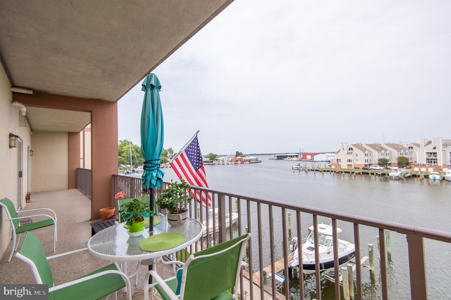 Wake up to shimmering views of Cambridge Creek and laid-back living in this beautiful waterfront condo. This light-filled 2-bedroom, 2-bath home offers a spacious open-concept layout, ideal for both relaxing and entertaining. The kitchen features updated cabinets with soft-close drawers and slide-out shelves, spacious countertops, a built-in microwave, dishwasher, stove, and refrigerator with water dispenser/ice maker. The open countertop area has breakfast bar seating for two. In addition to the cabinet storage, the kitchen has two roomy pantry/closets with shelves. 
The 48-foot-wide balcony runs the entire width of the condo and is accessible from the living room and from both bedrooms! It’s the perfect spot to sip morning coffee or unwind at sunset while watching boats glide by. The primary suite features a walk-in closet and an en-suite bath with a walk-in shower. The second bedroom is only slightly smaller than the primary. The property features a hall bath, a laundry room, and an open-plan living room and dining area. The unit has been updated with recessed lighting and bamboo flooring in most rooms and a dark cherry hardwood in the primary bedroom.  
All four sets of sliding doors to the balcony feature Hunter-Douglas vertical cellular shades. The primary BR shades are room-darkening, creating a restful sanctuary. Additional features include a 7 x 16 secure storage room across the hall from the unit, secure parking with one assigned spot and additional parking in front of the building. Building entry is secure with an access code required. A deeded boat slip is included in the purchase price, allowing you to explore the Choptank River and the Chesapeake Bay. This property is an easy walk to downtown restaurants and shops. What are you waiting for? This could be yours in time to enjoy the summer!