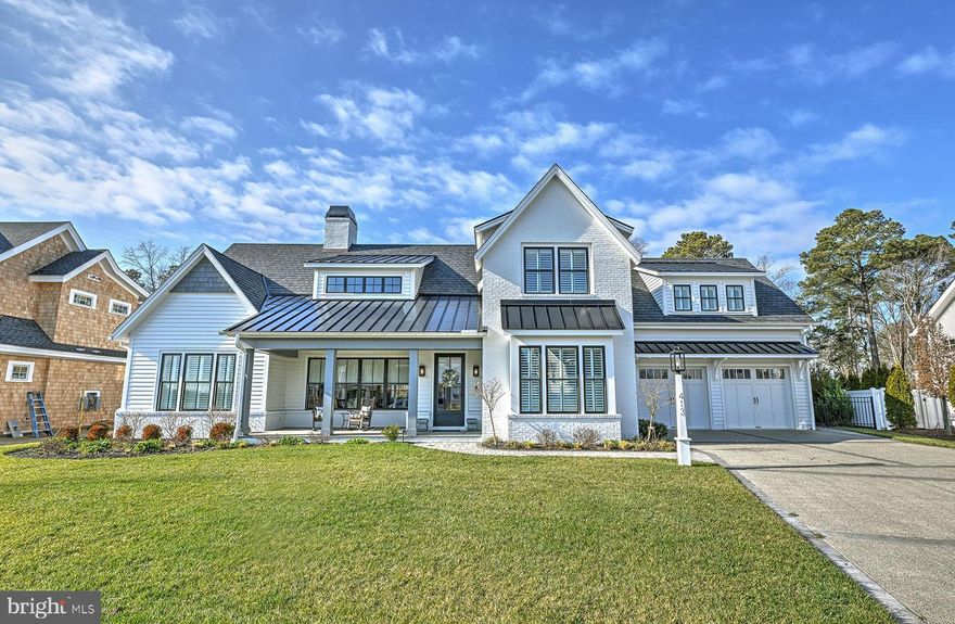Welcome to 413 Virden Way, an exceptional custom-built home in the sought-after Lewes community, Mariners’ Retreat. This stunning modern farmhouse sits on a .25+/- acre parcel backing to an undeveloped parcel and situated less than a ½ mile from a magnitude of popular restaurants and shops along 2nd Street, the Lewes Rehoboth Canal and within 1 mile of Lewes Beach – virtually every amenity of downtown Lewes is at your fingertips. Upon entry, you’ll quickly recognize the timeless appointments including wide plank white oak flooring, detailed moldings, expertly crafted built-ins, attractive fixtures, tasteful furnishings and more.
Featuring  3,975+/-  heated square feet, this desirable floor plan offers four spacious bedrooms, each with a private en-suite bath, two half baths and multiple living spaces for privacy and relaxation. The spacious gourmet kitchen is designed with striking quartz counters and backsplash, a large island with storage and breakfast bar, floating shelves, commercial-grade stainless steel appliances and a walk-in pantry. The kitchen is open to the great room where the wall of built-ins and cozy gas fireplace are a beautiful focal point. Complete with a wet bar and beverage fridge, this space was designed with entertaining in mind. The first-floor primary suite offers a private sitting room, executive office, bedroom with vaulted ceilings, dual walk-in closets, and a luxurious en-suite bath decorated with marble tile, dual vanities, and oversized, multi-head, spa style shower. The first level is also host to an impressive laundry room that allows access to the pool, outdoor shower and changing room. The second level of this stunning home is host to a second recreational room currently being used as a fitness room, 3 generously sized bedrooms each with upscale, en-suite baths, and ample storage that could be finished as future additional living space. The private yard features beautiful hardscape and landscaping that surrounds the custom 12.5'x 48' swimming pool. Heated for longer enjoyment, this pool features relaxing fountains, an automated safety cover and is like no other in the area. 413 Virden Way leaves little to the imagination and is being conveyed turn-key for convenience. This is your opportunity to be a part of one of the area’s most beautiful and convenient communities in downtown Lewes.