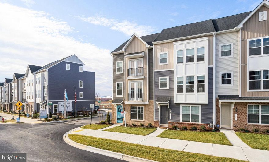 July Delivery. End Townhome! Fredericks Luxury Townhomes in Monocacy Center. Located near every amenity you will need. This 2008 square foot townhome at Market Commons features a 2 car rear load garage with an extra suite on the first floor and full bath. Use as an office or a guest bedroom for visitors. Impressive 9ft ceilings on all 3 levels. Gourmet kitchen with double wall oven and separate gas cooktop. Stainless steel appliances, Quartz countertops, grey cabinets, and luxury vinyl plank flooring throughout the 2nd floor. This is a 4 bedroom, 3 full bath, 1 half bath home with no exterior maintenance. Every convenience you need is within walking distance. This maintenance free community is the definition of Urban lifestyle. 1 mile to Rt 15, surrounded by shops, restaurants, grocery, entertainment and much more!! Only minutes from Historic Downtown Frederick. Photo Likeness of onsite model.