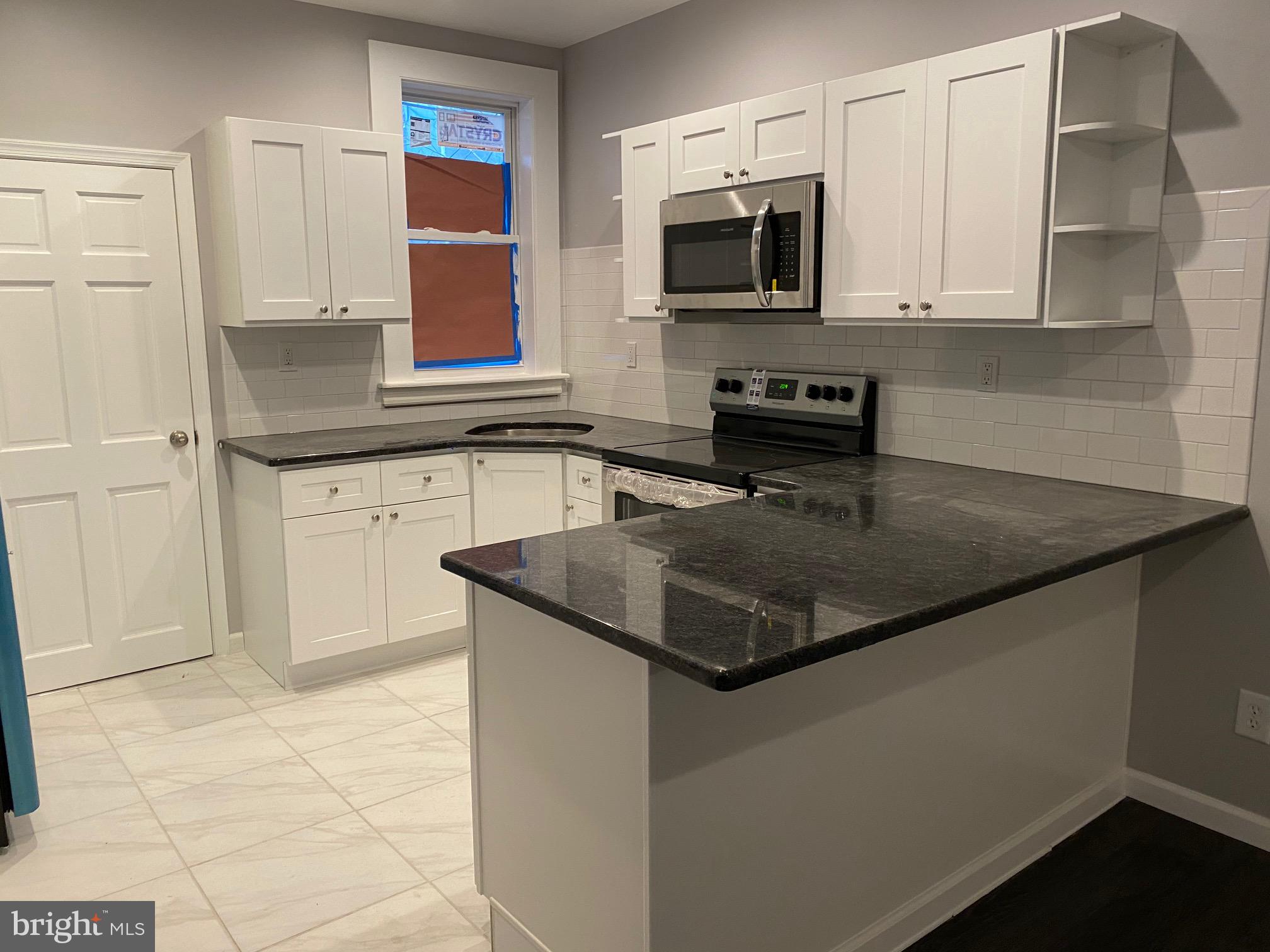 Fully renovated 3 bedroom 1.5 bath on a quiet, low traffic, tree lined block of Reno Street between 43rd and 44th Streets and between Brown and Parrish Streets. Near trolly lines and buses. Close to I76, Lancaster Ave, Belmont Ave, Girard Ave, University City, Brewerytown, Phila Zoo, Lowe's, ShopRite, Fairmount Park, Univ of Penn, Drexel Univ. for easy commuting. Large front porch and rear yard provide outside space. Enter vestibule into living room with large picture window, recessed lights and ceiling fan. Dining room with half bath powder room on main level. Open kitchen with penninsula, ceramic tile floor, granite countertops with tile backsplash, stainless steel appliances including microwave, range and refrigerator. Ample cabinets with large pantry cabinet and additional storage in rear pantry area perfect for additional shelving. Upstairs you will find 3 nice-sized bedrooms with closets and ceiling fans. 3 piece full bath with subway tile tub surround with niche and skylight bringing in tons of light. Washer/Dryer hookup in basement with wash basin and walkout door for convenient access and storage. Renovated with care and upgraded with above-rental finishes and fixtures. Luxury flooring on both levels with ceramic tile in bathrooms and kitchen and carpeted stairs. Recessed lights, security system and ceiling fans throughout. You will appreciate the touches that make this property a home. Available immediately.