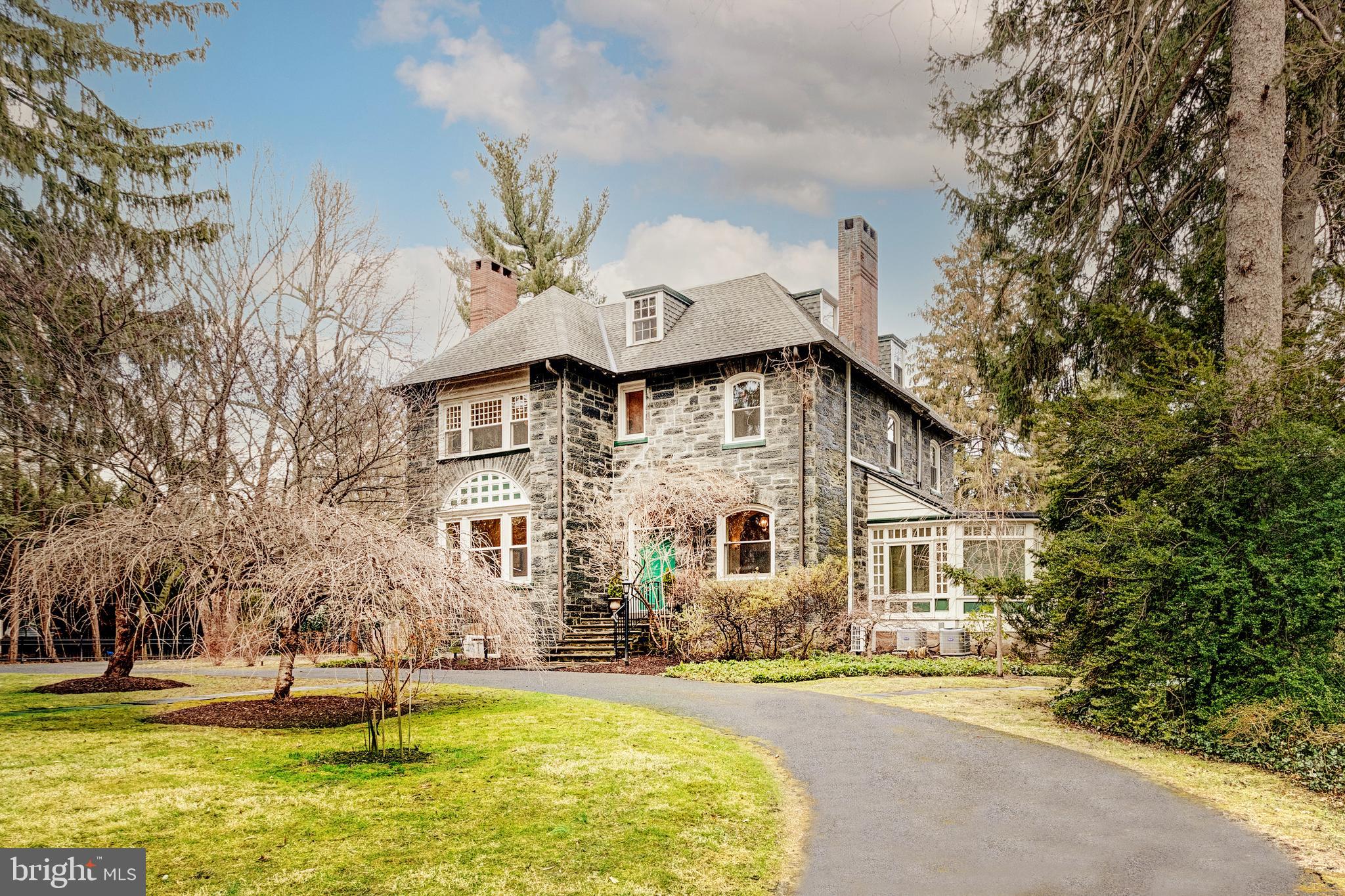 A blend of classic Victorian architecture and modern amenities will be sure to impress you at this exceptional six bedroom home on one of Chestnut Hill’s most picturesque streets. 8233 Seminole Street was originally developed by Henry H. Houston in partnership with architects, G.W. & W.D. Hewitt.
This Queen Anne style residence offer everlasting history and captivating curb appeal. Upon approaching the property, you’ll find a serene and oversized lot with lush plantings, seamlessly complemented by the home’s hipped roof, stone window sills, and arched dormers. Many original interior details still remain, including the custom millwork, soaring ceilings, and multiple fireplaces.
Enter into the center hall foyer and instantly take note of newly installed hardwood floors and incredible entertaining spaces. Formal living and dining rooms are complemented by a peaceful sunroom with walls of oversized windows and green roof. Both the solarium and the expanded chef’s kitchen with radiant heated flooring provide access to a sprawling rear deck, ideal for dining alfresco all summer long and taking in views of the property’s gorgeous gardens.
Upstairs, you’ll find three bedroom suites, each with their own private baths. The lavish primary bedroom is complete with a walk-in closet and a designer appointed bath showcasing a stall shower, soaking tub, and chandelier. The third level has two additional guest bedrooms that share use of a hall bathroom. Moreover, this floor leads to a home-office, perfect for today’s remote lifestyle, and a walk-in cedar closet that is useful for storage.
Steps away from regional rail, the village of Chestnut Hill, and the gorgeous Wissahickon Valley, the location of this home is one of its best amenities. You’ll enjoy some of the finest restaurants, outdoor spaces, and attractions available within the region! Come make this home yours.