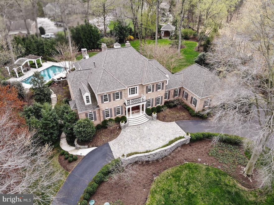 Welcome home! This Majestical, nearly 10,000 sqft colonial house sits on 1.8 acres of beautiful and private land. It has essentially been rebuilt from the inside out over the last  few years with extensive renovations done by master contractors. Exquisite landscape designed by Surrounds/Howard Cohen (PLA) with pool and intricate hardscape, new kitchen, all new baths throughout, main-level owner's suite, a large workshop in the lower level, finished 4th floor loft, and so much more. Upon entry through the grand foyer, the formal dining room & study flank you from the 2 sides. The entry hall continues to the grand family room, joined by the formal living room adjacent. The sensational kitchen offers generous entertaining and functional cooking/prep space that will delight chefs and enthusiastic home cooks alike, complete with adjacent breakfast room and sunroom. The main level also includes an intricate guest powder room, a mudroom & laundry area, and our fabulous owner's suite with gracious bath and dual walk-in closets. The upper level bedroom suites are complimented with designer baths, and graciously proportioned rooms. The lower level includes a billiards parlor, entertainment/media room with custom designed cabinets, shelving, and entertainment center. It also includes a fitness center, a large workshop, hobby room, wine bar & kitchenette, and a guest full bath that also serves as the pool bath, with exterior exit leading to the pool plaza.This estate is complemented by the outdoors, and the finishes are showstopping. The fabulous screened-in outdoor living room offers views of the pool, rear grounds, gardener's house, and the surrounding picturesque scenery.