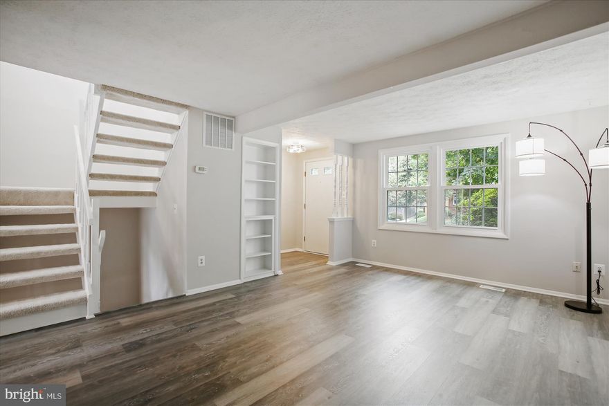 *WELCOME HOME* to this spacious and *BEAUTIFULLY UPDATED* 3-bedroom, 2.5-bath townhome in the highly sought-after Cherry Hill community, right in the heart of Falls Church City! Spread across three finished levels, this inviting home offers a bright, modern feel with stylish LVP flooring, a generous kitchen with eat-in space, upgraded counters and appliances that flows into the dining room with access to the fully fenced private yard—perfect for relaxing or entertaining. The upper level features a large primary bedroom with a walk-in closet, two additional bedrooms, and a full hall bath, while the lower level provides a versatile rec room, laundry/utility space, and a stunningly renovated full bath. Updated hot water heater plus washer and dryer.  Residents enjoy a community pool, assigned parking, and easy access to Big Chimney Park, the W&OD Trail, shops, restaurants, and the new Whole Foods, all within the top-rated Falls Church City school district!  RECENT updates include: Gorgeously updated full bath on LL (2025); updated 1/2 bath on main (2025), new water heater(2025), new windows (2025), brand new paint and new flooring THROUGHOUT (2025), newer full fence in rear (2020), newer Bosch dishwasher (2023)!!