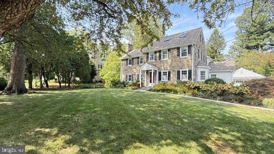 Situated on one of Penn Valley most desirable streets, 718 Braeburn Lane is  classic stone Colonial offering  a perfect blend of timeless character and modern updates. A  beautiful and welcoming foyer with hardwood floors leads into a spacious living room featuring a stunning fireplace centered for comfort and conversation, an  abundant of natural light that flows into the rest of the home effortlessly. The formal dining room sits just across the foyer, offering an inviting space for both everyday living and entertaining, a beautiful bay window with wrap around seating and steps away from a Chef's dream kitchen. The adjacent chef’s eat-in kitchen is thoughtfully designed with modern appliances, ample counter space, and custom cabinetry, and provides easy access to the expansive deck and lovely leveled  yard and gardens. A great room addition sits on the back of the home and offers the second gas fireplace and landscape of windows, a wet bar and custom cuilt-ins shelving. A well-placed powder room and large closets completes the main level. Upstairs, a gracious staircase  leads to the primary suite and large sitting area, huge walk-in- closets with custom organizers.The primary also offers a  beautifully newer bathroom suite with custom tile shower, dual vanities, radiant heating and a large shower with frameless glass enclosure and large linen closet. The second bedroom suite has its own bath and walk-in closet and multiple windows for lots of natural light.  The third bedroom is situated near the full hall bath  and a well placed second floor laundry area completes the second floor.  Upstairs the fourth bedroom Suite with added Skylights , hardwood floors and lots of storage defines this well appointed third level of living.  The lower level is a canvas  awaiting a potential game room, gym, play room or storage as it is currently being used.  A custom built detached garage  with an electric car charger that fits into the landscape perfectly is attached to the stunning yard and deck.  Curbside beauty at its finest! The outdoor setting is truly exceptional, with stunning perennial gardens and custom landscaping reminiscent of Longwood Gardens. Ideally located within walking distance to everything Narberth and the Main Line offers including upscale shops, and restaurants, and just minutes from Lankenau Medical Center, Bryn Mawr Hospital, and Center City Philadelphia.  Offering Lower Merion School District and some of the finest private schhols and universities with in minutes.   Welcome Home