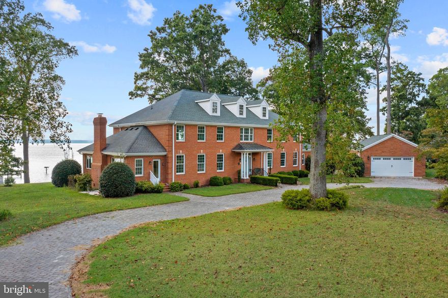 Welcome to York River estate for living your best life! (3-D Tour available) NEW PAINT. NEW CARPET. Fabulous sunset views over the wide river waters. 3.28 acres of land with mature shade trees and landscaping for year round beauty includes four structures: Brick Colonial Estate House, The Guest House Cottage, Brick Detached Garage, and Pump House!! Main house boasts river views from Living Room areas, Kitchen, Primary Bedroom,  Covered Porches, upper level rooms and Outside Living Spaces.  Wood floors. Enter the foyer and look straight through to the sweeping, breath taking water views of York River beyond!  MAIN LIVING ROOM has gas burning fireplace, and built-in bookcases on each side. Gorgeous sunset views. Double pocket doors  open to a  Large 2nd LIVING ROOM that features front to back sweeping views, natural light pours in, includes brick wood burning fireplace with wooden mantle that has built in plate holder slots and hidden stocking hooks.  Built-in firewood loading door means wood does not have to be carried through entrance, can be stacked inside wood storage area of mantle from outside  KITCHEN features pull outs and built-ins, even a baking tray drawer! No more unsightly trashcans, these are under counter and pull out for ease. Two wall ovens and a cooktop.  Oversized pantry and built-ins. Brand new 2022 microwave, taller counter height cabinets, breakfast bar that looks out large glass window to water and nature views.  Main Level PRIMARY BEDROOM designed with low windows for full river view, even when resting.  En-suite Primary Bath features separate soaking tub and walk-in shower, dual sinks and walk-out to hot-tub platform with outside shower. Primary over-sized, walk-in closet features Homeland Security fire-proof safe.  Main Level SECOND BEDROOM w en-suite bathroom and over-sized walk in closet. Main Level OFFICE with solid wood built-in shelves and drawers (approx 12') and extra deep closet with electrical outlet and light. UPPER LEVEL offers 3-5 more bedrooms (two do not have closets) and a central living area that is open and airy with full water view from inside or on upper level covered, slanted-floor, fiberglass coated deck on porch accessed through three sets of 8' sliding glass doors for rocking chair relaxation and fun. Kitchenette.  Brass outlet on center of upper living area floor makes charging convenient. Entire wing on upper serves as second apartment w walk-out to porch for water views, living area, bedroom area with en-suite modern bathroom w walk in shower and over-sized walk-in closet. Pull down steps to attic. Upper has additional hot water heater. All new Anderson windows with a transferable lifetime warranty.  House was deliberately built loaded with storage space.  Whole House water softener and central Vacuum. Whole House 2022 "Generac" brand generator.  Built-in wired for speakers,/intercom and ADT security system. New roof and gutter system 2021. This estate features mature landscaping of tall trees and blooms for year round beauty. Outdoor Room on the River's edge surrounded by deliberate landscape for quiet, intimate time together. Dock stretches out 150 ft into river for boating, oystering, swimming. See the wonderful Osprey on their nest box on the river? Landscape features hardwood trees, maples, fig tree, crepe myrtle and English Boxwood bushes.  Firepit conveys. Across the River is Navy installation areas and Camp Perry. 

Guest House Cottage is 1,152 SF and has charming country cottage front porch for quiet evenings, cozy and ample interior has living room-dining-kitchen combo, 2 bedrooms, inside laundry, a bonus room created from covered porch, and its own attached garage.   New Roof 2021.

Detached 2+ car brick garage built in 2021 on circular drive way with high ceiling, windows and electric. Door in rear for mower-tractor & cars door in front. Circular driveway is finished with pavers.