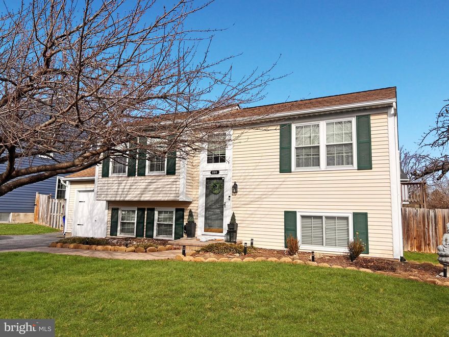 Cozy and charming, this well-maintained 4-bedroom, 2-full-bath home features hardwood flooring, neutral paint colors throughout, and built-in bookshelves that add character and function. The bright kitchen offers white cabinetry and stainless steel appliances. The recently remodeled lower-level bathroom provides a fresh, modern touch. Enjoy outdoor living in the great flat, fully fenced backyard with a deck—perfect for relaxing or entertaining. Conveniently located near major commuting routes and shopping.