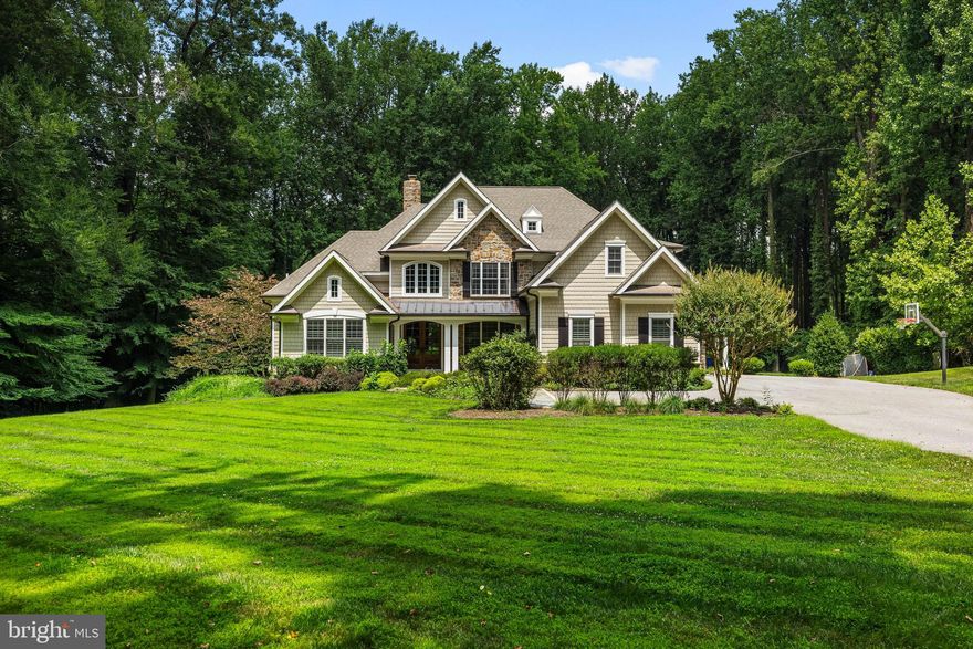 Nestled in close proximity to the Greenspring Valley Hunt Club, 224 Hopkins Lane is a testament to privacy, luxury, and meticulous attention to detail. This exquisite property boasts four bedrooms, each a haven of comfort and style, complemented by four full bathrooms and a powder room, ensuring ample space and convenience for residents and guests alike. With its private setting and beautifully designed spaces, both indoor and outdoor, this home stands as a paragon of elegance in a highly desirable location. Guests are welcomed into a beautiful foyer awash in natural light, where oak glazed double entry doors open to reveal a two-story space adorned with wide plank quarter-sawn oak flooring. The foyer seamlessly transitions into various living spaces, including a study, dining room, and the great room, which features a two-story vaulted ceiling and accented by a full-height stone chimney. The dining room, with its triple window offers the perfect space for formal gatherings. The adjacent study provides a quiet retreat for work or relaxation, with its vaulted ceiling and custom built-in bookcases. The enviable custom gourmet kitchen serves as a masterpiece of design and functionality. Beautiful custom cabinetry, granite counters, and a suite of high-end appliances, including a Sub-Zero refrigerator and Dacor gas cooktop, speak to the quality and thoughtfulness infused into every aspect of the home. The space is open and inviting, with a beamed/coffered ceiling and a breakfast area that looks out onto the lush gardens through a bay window. With open flow through post and beams, the warm and inviting vaulted Family Room awaits with its stone fireplace for cozy evenings by the fire. The outdoor spaces are a fitting extension of the home's interior beauty, with gardens, landscaping, and hardscape that include a large back patio, creating a private oasis ideal for entertainment or solitude. The exquisite gardens and meticulous landscaping frame the property, offering seasonal colors and textures that delight the senses. The primary bedroom features a wide bowed bay window and access to the covered patio porch, offering serene views of the property's stunning outdoor spaces. The adjoining primary bath is a spa-like retreat, with travertine marble, a claw-foot soaking tub, and a large shower stall, ensuring a serene start or end to any day. The additional bedrooms are equally well-appointed, with features like vaulted ceilings, walk-in closets, and private baths. The lower level extends the living space with a recreation room , game room with wet bar and exercise room with a sauna and adjacent full bath. With expert craftsmanship evident in every detail, 224 Hopkins Lane offers design, comfort, and privacy. Its gardens, exquisite interior spaces, and thoughtful details create a living experience that is both luxurious and welcoming.