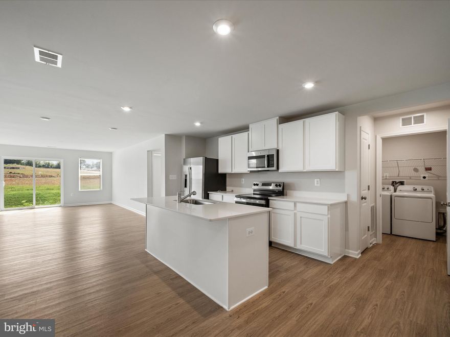 Welcome to this stunning end-unit Sagamore Townhouse/Villa by Stanley Martin, already built and move-in ready, offering 3 bedrooms, 2.5 baths, and 1,877 sq. ft. of stylish living space with all upgrades included in the price. The open-concept main level features a primary suite with en-suite bath, a chef-inspired kitchen with quartz countertops and a large island, and a bright dining and family room filled with natural light—perfect for entertaining. Upstairs, you’ll find two spacious bedrooms with walk-in closets, a full bath, and a versatile flex room ideal for an office or second living space. A 2-car garage provides plenty of storage, while energy-efficient construction helps keep monthly bills low. Perfectly located in Charles Town, enjoy walkable access to Starbucks and the dog park, easy trips to Harpers Ferry, outdoor fun at Jefferson Memorial Park, gaming at Hollywood Casino, and quick commutes to Leesburg, VA—just 30 minutes away. End-unit Sagamores sell quickly, so don’t miss this opportunity!