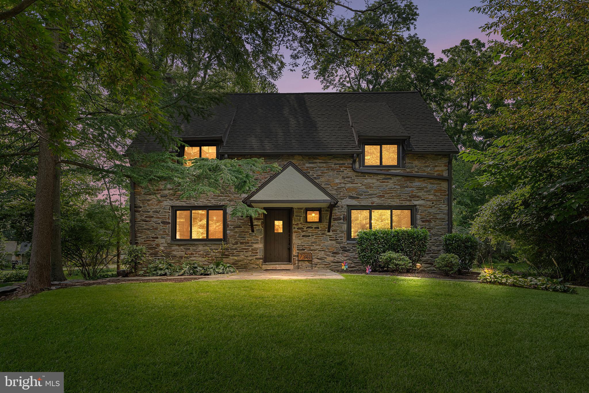 This move-in ready 4-bedroom Tudor-style home is nestled on a peaceful cul-de-sac in sought-after Swarthmore, with dual access from Swarthmore Ave and Crest Ln. Blending original charm with thoughtful updates, the home features tall ceilings, gleaming hardwood floors, and a bright living room with built-in shelving and a fireplace. The upgraded eat-in kitchen includes modern stainless steel appliances, Quartz countertops, white shaker cabinets, subway tile backsplash, and a breakfast bar. A versatile second-floor layout offers a half bath and a flexible bedroom or bonus room with French doors and vaulted ceilings. The top floor hosts three bedrooms and two full baths, including a spacious primary suite with a walk-in closet with a window and private ensuite bath. The fully finished water proofed basement provides additional living space to fit your needs, a storage area, laundry area, and a second half bath for convenience. Additional highlights include an attached two-car garage with electric vehicle charger. Convenient to Swarthmore College, Scott Arboretum, local shopping, dining, and regional transit. Schedule your showing today!