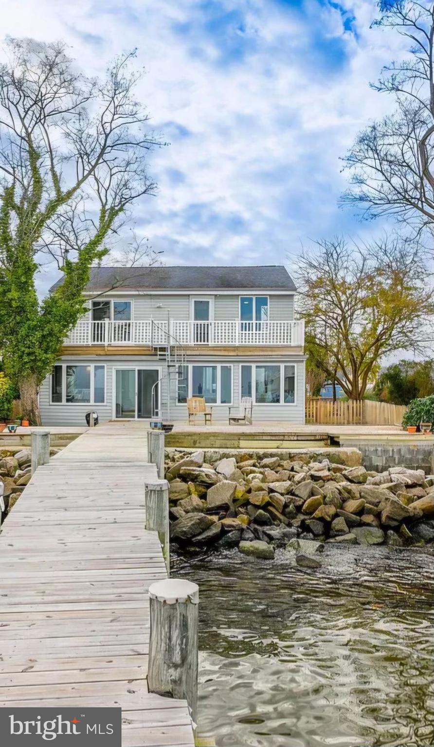New season, new price! Unbeatable location & views. This wonderful, exceptional waterfront home is located on the Chesapeake Bay in the desirable and established neighborhood of Bayside Beach, Pasadena. Sellers currently have flood insurance under $800/yr. The 3BR/2BA house is nestled between Boyd’s Pond, the Patapsco River and the Chesapeake Bay with water access on both sides. Water views can be seen from every room of this newly remodeled home. Community beach available for Bayside Beach property owners. This house will become a sanctuary enhanced by nature at its finest. Imagine your new home with peaceful breezes enhancing a water-enhanced sunrise and sunset each day. Boat lift conveys with the property ……
There are 3 bedrooms upstairs with a deck off the primary bedroom and 2nd bayside bedroom that spans the width of the house looking over the water. Wake up to beautiful sunrises as you watch the ships move from the bay into the Baltimore Harbor trailed by the many and varied species of waterfowl. A cozy screened-in porch on the front of the house overlooks Boyd’s Pond where the simply gorgeous sunsets can be enjoyed in the evenings as the sun sinks into the western sky. As you move within and around this beautiful home, your stress dissolves away into the peaceful, calming water-filled landscape.
……………
Downstairs is a bright sunroom with a wall of windows and a large outside deck inviting you to entertain large gatherings of friends and family. Moreover, there is a bayside dock with a 10-ton boat lift on the property to house your boat or wave runners just steps from your back door. A 14x20 ft shed also sits on this gorgeous fenced-in waterfront property – designed to store lawn equipment and household goods, provides a workshop, and keeps the canoes and kayaks that you will want to launch from the dock right into Boyd’s Pond.
…………
This is a one-of-a-kind waterfront home that is comfy, warm, and exciting to live in! The neighborhood is friendly, and the location is not only beautiful, but also close to Baltimore and the BWI airport (both only 20 min away). Fort George G. Meade and Annapolis, Maryland’s historic and quaint capital city are but a 30-minute drive and Washington DC is less than one hour away by car. This house is close to shopping, coffee shops, schools, restaurants, and transportation hubs yet when you park the car and step onto the property you become a part of a serene escape from the hustle and bustle of the everyday world. Please plan to visit – you are so very welcome!
……………
Land/property included on both sides of Lake Drive. Shed is on property.
……………
Some additional details you may be interested in:
…………….
Heat: Oil Water: Well Sewage: Septic Tank Dryer & Stove: Electric: washer also conveys
……………
HOA: Bayside Residents Association; the cost is taken out in the taxes.
……………
Roof: approximately 10 years old
………….....
Two French Drains Installed in 2023
……………
2024 Additions:
…….........
Bathrooms: New tub, shower, and tile; Kitchen: New marble backsplash, new countertops, new stove; Floors: New vinyl planking throughout house with new carpet in BR2 and BR3; new vinyl floor tile in kitchen; Paint: New paint and trim throughout the house; Fans: New ceiling fans in Kitchen, BR2, and BR3; There are ceiling fans in all rooms including the sunroom and front porch; Lights: New DR hanging light; new bathroom lights; new bathroom light and exhaust fan in upstairs bathroom; Fence: fully-fenced yard. Walkway: New front walkway; Docks: New dock onto the pond; dock on bayside is three years old; Smoke Alarms: one new smoke alarm downstairs and one upstairs.
