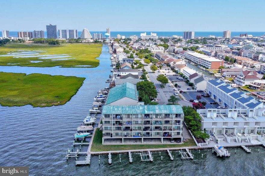 Gorgeous remodeled 2nd-floor unit located in the desirable Pintail Point Complex. Step inside & feel welcomed by the natural sunlit open floor plan with beautiful engineered flooring, recessed lighting & high end contemporary finishes. Gorgeous kitchen offers soft-closing cabinetry, center island with stylish  lighting, quartz countertops and stone backsplash. Light filled living room with a sliding glass door opens to the balcony to soak in the peaceful views overlooking your deeded boat slip on the bay. Remodeled bathroom with stone accented shower. This unbeatable location offers many perks including an array of shopping centers/dining options such as Liquid Assets, Bull on the Beach, & Acme grocery store. Complex amenities include elevator & pool.