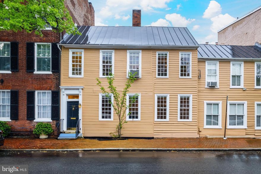 Charm and atmosphere abound in this bright 2-bedroom, 1-bath apartment on the 2nd level, in the heart of Old Town Alexandria.  The spacious living room offers hardwood floors and tall windows.  Archways between rooms are a lovely feature.  The dining room with another tall window features an antique crystal chandelier and hardwood floors.  White cabinets along with a built-in china cabinet with drawers and storage make this kitchen feel like home.  A stack washer-dryer is in the apartment.  The sparkling white bath with tub/shower is located in the hall next to the primary bedroom which also has hardwood floors.  Bedroom #2 is smaller and could be a guest room, a nursery or an office.  A small balcony, perfect for a bistro table, offers a peaceful place for morning coffee or an evening under the stars.  Enjoy living in close proximity to Old Town's fine restaurants, boutiques, several parks, and the exciting Potomac waterfront.  With a prime location and easy access to amenities, this is a wonderul place to call home!
