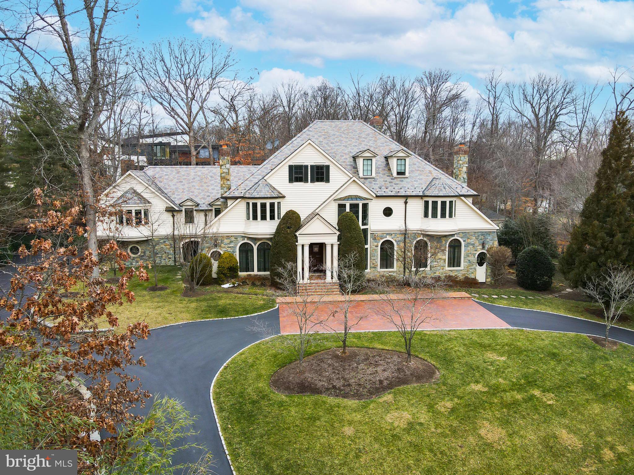 Come home to the definition of luxury in the heart of Potomac. Built by acclaimed Gibson Builders, this breathtaking, one-of-a-kind property is filled with custom features, exquisite design and a warmth so rarely found in homes of its size. This home exudes high-end practical living with expert craftsmanship, a tasteful interior and thoughtful layout. The two-story grand foyer evokes Old Hollywood glamour with its curved staircase and gleaming crystal chandelier (straight from the set of Boardwalk Empire). To the right of the foyer is a formal living room with stone fireplace and hand painted ceiling by local artist Maggie O’Neill. The entire house has a gracious flow, leading from the living room to a stately clubroom, complete with a full wet bar and billiards space. This property is well suited for both large-scale entertaining or more intimate living. The centrally located great room serves as the heart of the home and is the perfect intersection of form, function and technology. Custom built-ins, a coffered ceiling and beautiful hardwood floors bring a warmth to such a grand space. The state-of-the-art drop-down movie screen makes this an ideal gathering spot for entertaining friends or cozy movie nights. Adjacent to the great room is a top-of-the-line chef’s kitchen with wooden ceiling beams, paneled appliances and an oversized walk-in pantry. There is an adjacent wet bar and sun-drenched breakfast room with direct outdoor access. The expansive formal dining room is the optimal space to host holidays and all of your special events. Take the elevator to the upper level which boasts six well-appointed bedrooms. The unparalleled owner’s suite has a sitting area, custom walk-in closet, luxurious bathroom for two with soaking tub and balcony access. The second jaw-dropping owner’s closet feels more like a boutique--it’s a fashion lover’s dream come true! There are five additional bedrooms on the upper level, all with en-suite bathrooms and walk-in closets. One of the bedrooms serves as a spacious second owner’s suite with sitting area. An upper level bonus room with built-ins and a gas fireplace is the perfect flex space that can be used as an office, homework area, playroom, or meditation space. The lower level has a temperature-controlled wine cellar, full gym, massage area, sauna and spa shower/changing room. There is also an en-suite bedroom, additional wine room, a recreation area with bar and ample storage space. This property offers your own private Oasis with a beautiful pool and spa and handsomely landscaped grounds. Divine outdoor recreation extends from the covered stone patio to the built-in BBQ area to the custom pool house complete with kitchenette. Other amenities include a four-car garage, newly-renovated laundry room with steam machine and security system. This home is truly a masterpiece that will be cherished for generations to come. Minutes to Potomac Village with easy access to the DC Metro area.