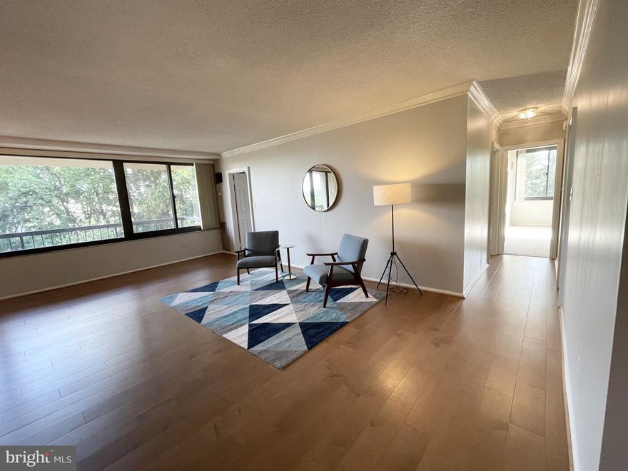 Investor opportunity with above-market rent in place.   This gorgeous condo home is a total package with  ALL UTILITIES INCLUDED  + IN-UNIT WASHER/DRYER + 1 COVERED PARKING SPACE + YES TO PETS!!!  Welcome home to Place One Condominiums, in sought-after and convenient West Alexandria.   Spacious and bright corner end unit 2-Bedroom + Den/Flex/3rd bedroom,  3-bathroom  condo home features an inviting open floor plan.  This is the largest floor plan unit in this condo complex!  Over 1400 sq ft!  Freshly updated with new paint and carpeting (2024) in versatile neutral colors fits every decor style.  Engineered hardwood flooring and elegant crown molding accents the light-filled Living/Dining room area.   Step onto the expansive balcony that overlooks the landscaped grounds and treetop views overlooking the cityscape and is super private!   Large Kitchen is on-trend in all white with counters and cabinet space galore + a pantry closet.   Kitchen features electric cooking with updated appliances, painted cabinets, refreshed cabinet hardware (2024), and replaced microwave (2024) has an air fryer feature.   This condo home features 2 bedrooms:   The spacious Primary Bedroom suite offers a walk-in closet, a 2nd closet, and an attached Primary Full Bathroom. The 2nd Bedroom with attached Full Bathroom is also generously sized, boasting a large closet and abundant natural light via large window wall; Den/Flex/3rd Bedroom includes built-in shelving and attached Half Bathroom and is directly off the large Living Room/Dining Room space.   A stacked washer/dryer unit and additional storage room completes this well-designed layout.    Place One Condominium includes an array of amenities included in your condo fee including a generously sized pool and picnic deck area, tennis courts, game room, and lots of social community events all year long.    LOCATION, LOCATION, LOCATION!!!   Nearby parks, regional library, retail, food shopping, recreation, Alexandria City schools, and services, and access to main NoVA commuter routes all just minutes down the street or via access from DASH, WMATA busses or close-by King Street or Van Dorn Metro stations.   Place One is approx. 10 miles into DC, approx 15 miles to Fort Belvoir, Tysons Corner, and National Harbor, and approx a 60 minute drive to many Virginia wineries and breweries.   Property is virtually staged; tenant occupied through 10/2026.   MLS disclosures, offer guidelines, floor plan pdf are all online.    Owner reserves the right to set an offer deadline and accept an offer outside of the deadline.    All showings done by appointment or contact agent for showing appointments or questions.   It's effortless living at Place One!  Welcome home!