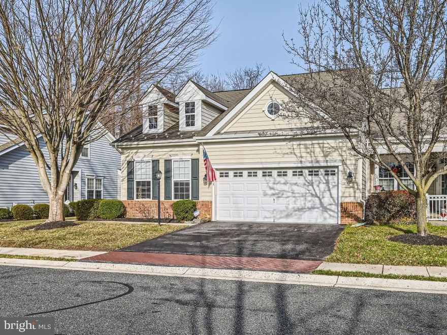 Gorgeous 4BR/4BA semi-detached Townhome located in the gated community of Bulle Rock.  Park in front of the two-car garage and make your way past lush green lawns and landscaping, then open the door into your forever home. The main floor offers an abundance of living space beginning with an oversized living room with vaulted ceilings and a double sided gas fireplace. On the other side of the fireplace is a spacious play room or the ideal place for a home office. On the right of the entry is the first of four bedrooms, a large room ideal as a guest room, and a full bath. A spacious kitchen offers plenty of cabinets, a separate pantry closet, a coffee bar area, black stainless appliances, beautiful granite countertops, and a double stainless sink under one of two pass throughs into the living room.  A long peninsula gives separation between the kitchen and spacious dining room. Just off the kitchen is the convenience of the main floor laundry in a mud room with access to the garage featuring a painted and sealed concrete floor.  The main floor is not complete without an oversized owners suite boasting tons of natural light, a large walk-in closet with custom built-ins, and a newly remodeled en suite offering a a double sink vanity, walk-in shower, and a jetted tub. The staircase to the second floor gives you a view of the lower level as you make your way to the open loft space ideal as a family room. The upstairs bedroom is spacious featuring a board and batten feature wall and a walk-through closet into a full bath that can be accessed from the family room.  On the lower level is where the family enjoys time watching movies in a spacious media room with stadium seating, or playing games in the game room like shuffleboard, or just enjoying a cold drink at the bar featuring a custom wood bartop. A large walk-in storage room and the remaining bedroom and full bath with a walk-in glass enclosed shower, completes this floor.  From the main, floor sliding doors take you to a large deck that is surrounded by green space.  This home is move-in ready, located in a gated community on Bulle Rock Golf Course, and features recessed lighting and luxury flooring and carpeting throughout. Imagine all this and in close proximity to restaurants, shopping, and commuter routes.