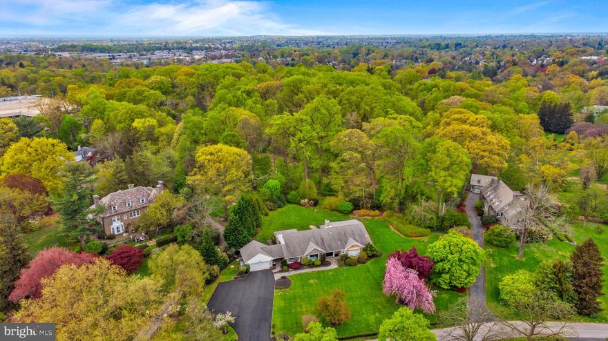 Sunday, 5/2, OPEN HOUSE CANCELLED.   Do you want the best house with the best yard in the best location?  Look no further.   Completely renovated between 2017 – 2021, no expense was spared to optimize the style and function of this beautiful stone Cape Cod home.  Ideally situated on over 1.17 acres of park-like land with private access to the Lankenau walking trail, this property offers  privacy within a neighborhood that is walkable to shopping, places of worship and commuter rail.  Step through the front door and into the entry foyer and you will notice that the beauty of the grounds  is brought indoors through many large windows and doorways.   High ceilings and hardwood floors throughout the house highlight the large spaces and open floorplan.   From the foyer with coat closet and powder room, step into the dramatic Great Room with stacked stone fireplace, barreled ceiling and wall of windows.  Pella sliding doors lead to a stone patio and back yard.   This room opens to a lavish gourmet kitchen featuring Italian Carrera Bianco marble countertops and island as well as custom designed, soft-close cabinetry and pantry.  A  Sub-Zero refrigerator/freezer, Sub-Zero beverage refrigerator, Wolf 6-burner gas range with commercial-grade Wolf vent/hood, Wolf microwave, Bosch stainless steel dishwasher and two stainless steel sinks make this kitchen both a showplace and a serious workspace.    The kitchen also has an informal dining area with door to the patio-- perfect for everyday meals.  Off the kitchen is a convenient laundry room with front loading washer and dryer.  The formal Dining Room is large enough to accommodate holiday gatherings and opens up to the formal Living Room; both rooms offer sweeping views of the front lawn from windows that nearly span the entire wall.  On the other side of the entry foyer are three generously sized bedrooms.  The  Primary Bedroom offers French doors to the back patio, his and hers walk-in closets and luxurious bath with oversized shower, soaking tub, double sinks and radiant heat floor.  Bedroom 2 features an Urban Woodcraft, solid core barn door on the closet and sunny windows facing the wide side yard.  Bedroom 3 has a large front-facing bay window and walk-in closet with built-ins.   These bedrooms share a Jack and Jill full bath with tub, double sinks and radiant heat floor.  Up on the  2nd floor are two additional bedrooms with Urban Woodcraft barn doors.  The 1st of these, Bedroom 4, is oversized and perfect for guests with direct access to the  full hall bath.  The 5th bedroom is currently used as a home office.   Completing this floor is a bonus space with sky-light, the perfect setting for reading or studying.  The finished basement has a wet bar, a huge recreation room with outside egress and a powder room.  The basement also provides plenty of storage space.   Jonathan Adler light fixtures throughout the home.  All exterior doors are 20 gauge steel with Pella screen/storm doors.  Two car garage with new door and newly paved 4,300 sqft driveway.  HVAC- 2017 with 3 zones:  basement, bedroom area and living area; Gas Boiler- Oct 2019, Water Heater – Dec 2020.  Whole house generator.  Award winning Lower Merion schools.