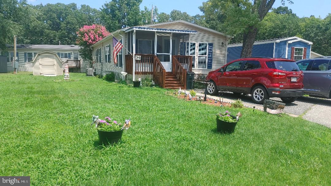 Come see this well maintain 2 bedrooms 2 full bathrooms home. This home offers 1,272 SF of living area that comes with enclosed front porch, a back porch, new roof in 2020 new HVAC system installed in 2024, new stove in 2024, the washer was replaced in 2020. This home offers an eat-in kitchen with large windows, separate dining room, laundry room which has full size washer & dryer. The primary bedroom is large with double closets with a large spacious bathroom, beautiful maintained flower beds, 1 shed. Buyers must complete the park's application for approval. The monthly lot rent is $1,186.00. Don’t miss out on this gem of a home.