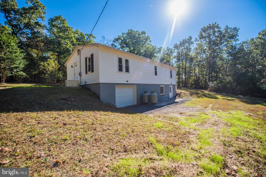 Remodeled home on 5+ acres in small subdivision with light restrictions and private community lake. One level living with open floor plan. Large yard surrounded by trees to provide plenty of privacy. Basement is ready to be finished out with bathroom plumbing already available. Brand new kitchen, bathrooms, roof, HVAC and appliances. Move in ready!