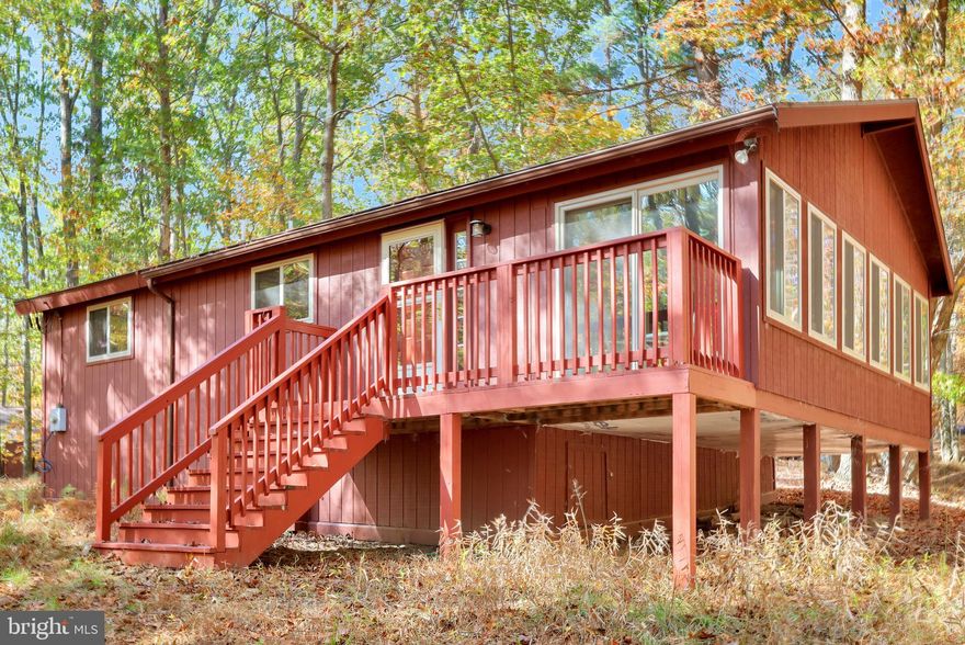 Class A Membership Available.  The Woods Resort.  Play where you live!  This very sweet home is perfect for a full or part time use.  Everything you need in a beautifully wooded setting.  The home features a fully enclosed room that once was a screen room, not climate controlled but easily able to utilize any time of year.  There is a wood burning fireplace in the great room and a breakfast counter in the kitchen area.  This home comes furnished with very nice modern decor.