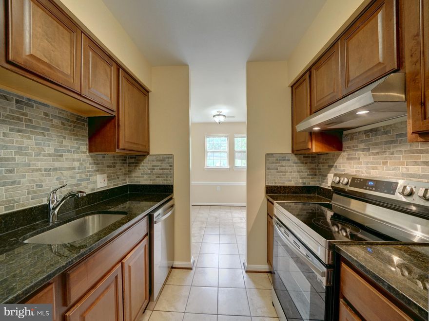 Available immediately! Fully renovated ground floor (1st level) condo in Montgomery Run. 2 bedrooms and 2 full baths. Unit features luxury vinyl plank floor in living room with walkout to rear deck/balcony. Ceramic tile floors in dining room, foyer, kitchen and both bathrooms. HVAC system has been updated. Upgraded kitchen with updated dark wood cabinetry including granite countertops, ceramic tile backsplash, Stainless Steel appliances and stacked front loading washer / dryer. Large primary bedroom with walk in closet and full en-suite bathroom with granite countertops, upgraded vanity and ceramic tile shower surround. 2nd bedroom and full bath with tub and ceramic tile in hallway. Water and HOA fees included in rent. Secured (locked) entrance in building with interior access to front door of condo. Community has outdoor pool, playground and open common area space. Walk to Shipley's Grant shops, restaurants. Convenient access to 100, 95, 295 and 29.