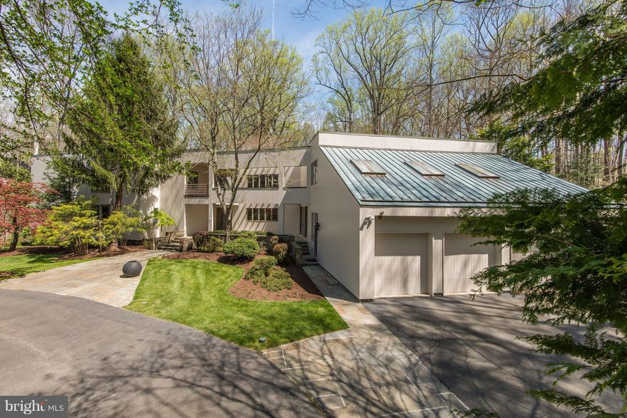 Rare Contemporary sited on over1 flat private acre! Langley Forest! 5 min walk to trails to Potomac River. Open flr plan w/ Marble foyer, whole house speaker sys, main level Master w/ office/den. Glass walled living rm w/ fp & built ins. Butler's Pantry w/ Wine Cellar. Dramatic Great rm. UL w/ media rm, in-law suite w/ kitchenette & 4bedrms. Landscaped gardens, running stream, backs to parkland!