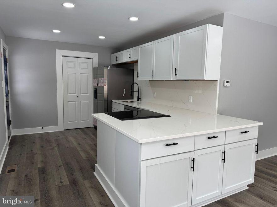 Step inside this beautifully remodeled single-family home, offering modern upgrades and stylish finishes throughout! Featuring three spacious bedrooms and a stunning upgraded bathroom with a full tile surround shower, updated vanity, and sleek fixtures. The inviting living area flows seamlessly into a gorgeous kitchen, complete with white cabinetry, quartz countertops, and stainless steel appliances. Enjoy fresh paint, new flooring, recessed lighting, and so much more! Situated on a .28-acre lot, this home offers plenty of space to relax and entertain. Conveniently located just a short drive from Route 100 & Route 2, with easy access to the Magothy River—this home is a must-see!