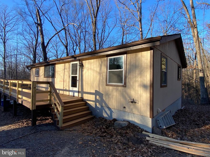 Country living and close enough to town and at an affordable price.   Blank canvas here for you to add your finishing touches on and make it home.   Inside primed ready for your paint colors.  New Composite decking just installed.  Home is selling AS IS and will most likely need conventional financing due to some repairs still needed. Perfect for a 203K or Conventional loans.