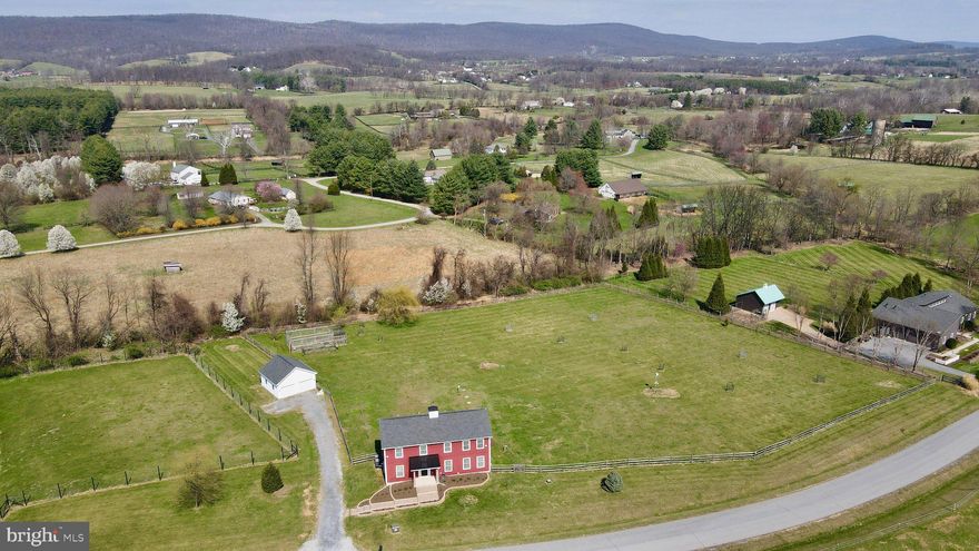 Welcome home to 15615 Whispering Knoll Court. A stunning 5-bedroom, 3.5-bath retreat nestled on 3.07 private acres in the heart of Hillsboro. Built in 2017, this thoughtfully designed home offers the perfect blend of space, comfort, and modern updates. Situated amongst the beautiful wineries and rolling countryside that Loudoun County is renowned for, and just a short drive to the charming towns of Purcellville and Round Hill, the location is as special as the home itself. Step outside to your brand new screened porch (2025) and take in the picturesque, fully fenced yard complete with a garden and newly planted trees; your own private sanctuary. Inside, the grand two-story living room with gas fireplace sets an impressive tone. Two primary suites (one on the main level and one upstairs, each with en suite baths) offer incredible flexibility for multigenerational living, guest accommodations, or simply planning for the future. The well-appointed kitchen features a large island, granite countertops, generous cabinet space, and stainless steel appliances. Fresh carpet and paint (2026), new washer (2025), new dishwasher (2025), and new microwave (2023), and all other appliances and major systems believed to be 2017.  The detached 2-car garage and an 800+ sq ft unfinished basement round out this exceptional property and provide so much room to grow. You must see this rare Hillsboro gem!