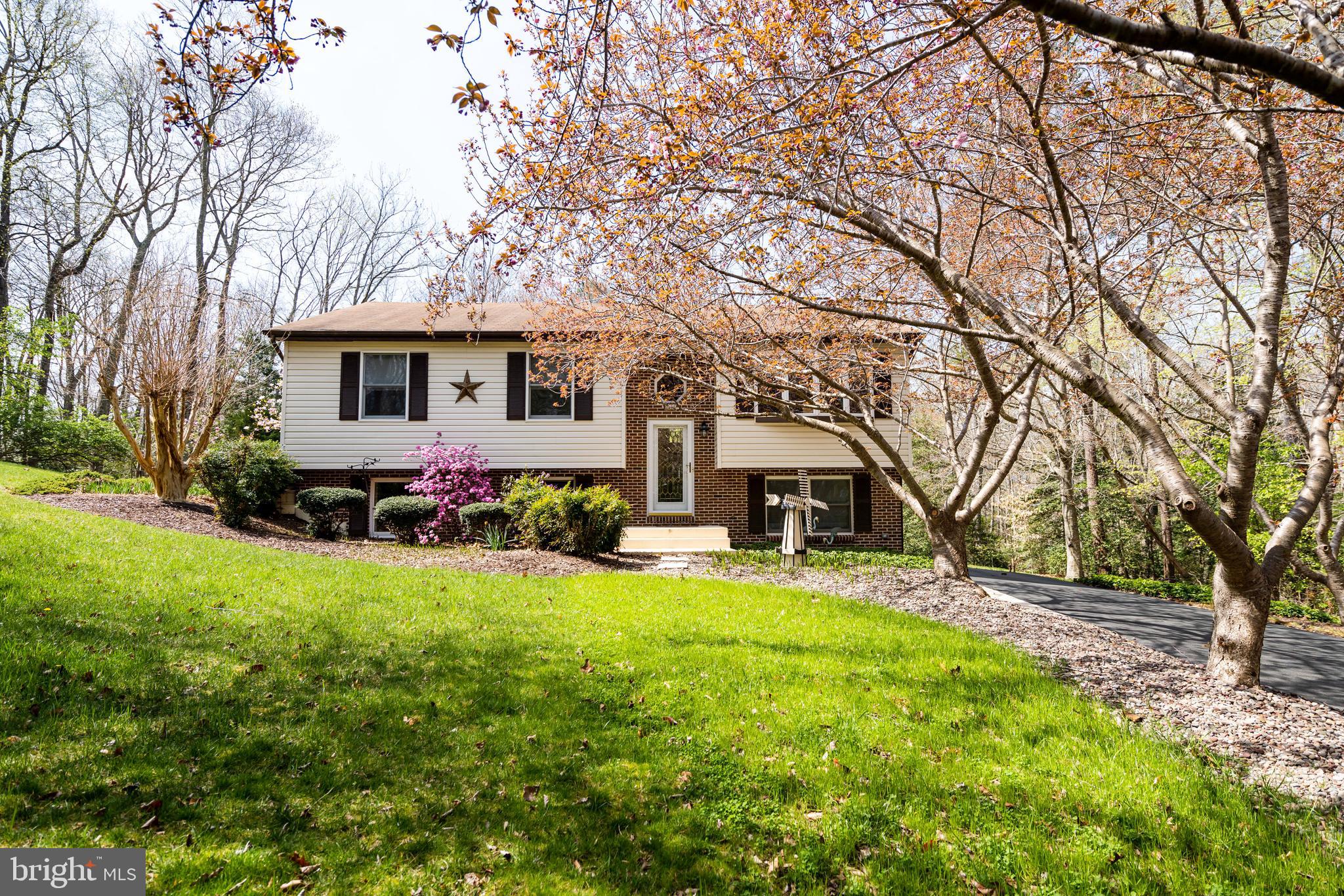 This gorgeous home needs a strong Buyer who will love it as much as the Seller does! At no fault of it's own- 2nd contract/Buyer's financing has/is falling through. EVERYTHING IS DONE, Title work is through Lakeside Title, inspections, FHA appraisal, etc. Home is ready to go! Gorgeous, very loved, roomy, Split Foyer in CRE! 4 bedrooms and 3 Full Baths! The Kitchen is a WOW Factor! This Kitchen is GORGEOUS with Granite Counter Tops, Upgraded Cabinets w/trim, Wood Back-Splash, High End Upgraded Samsung- Stainless Steel Appliances, Huge Island with additional outlets and cabinet storage underneath. The ceilings on the upper level are vaulted with a sky light, which offers a lot of natural light. It's very comfortable and welcoming. There is Cherry Hardwood Flooring (real hardwood) that just gleams and is throughout the Eat-In Kitchen, Living Room and Hallway. The Primary Bath (Master) has been redone with a Rain Shower and Rustic Tile. The Upper deck can be accessed from the Primary Bedroom and off of the Eat-In Kitchen area. The decks are fabulous for entertaining with a built in canopy for sun protection. All the windows and sliding glass doors have been replaced within the last few years and the hot water heater is less than 2 years old. The basement is fully finished with a large family room, surround sound speakers, 4th bedroom, 3rd Full Bath, upgraded carpet, Wet Bar, propane Fireplace, recessed lighting and an AWESOME Laundry room.
Exterior of the home is just as charming as the interior! The Cherry Blossoms are gorgeous upon pulling in the driveway, when in bloom! The flower beds are immaculate with River Rock, lots of various beautiful flowers/vegetation, rose bushes, stone walkways, multiple decks, a unique patio with a Hot Tub that is less than 2 years old and Pergola! This is your own private oasis. LOTS OF PRIVACY! The shed is very roomy, great for additional storage. There are even leaf guards on the home's gutters and an underground Sprinkler System! The Sellers did not miss a beat when upgrading this home. Very convenient to PAX River.
Must also get prequalified through one of listing agent's preferred lender, due to all the financing issues Seller has dealt with.