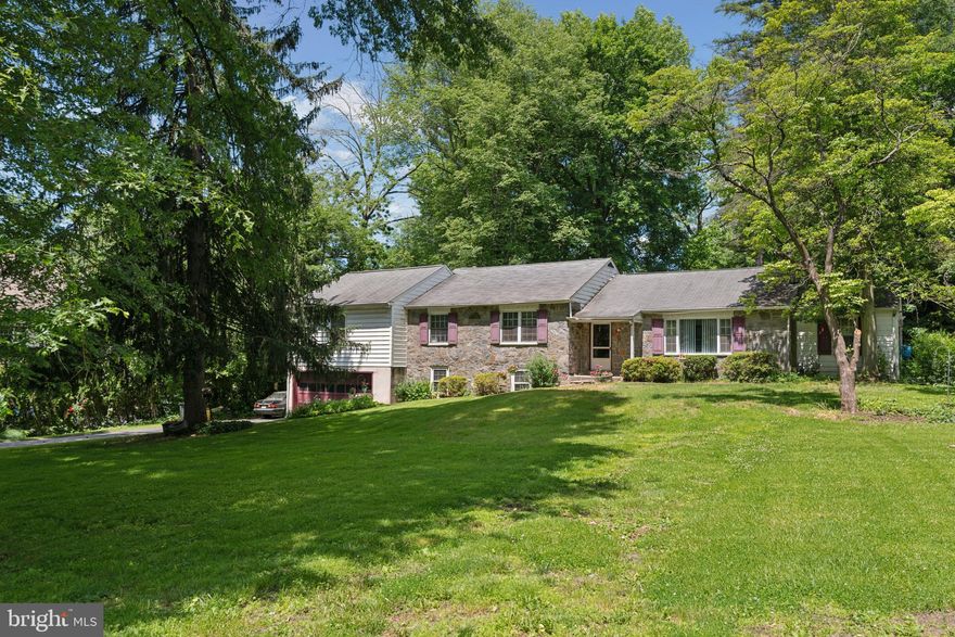 Welcome to this expanded stone ranch at 474 Barclay Road. This property offers an incredible location, great lot, and a wonderful opportunity to create the home of your dreams. Located on one of Bryn Mawr's beautiful tree lined streets, you’ll notice this house is one of the few originals left that were built in the mid 1900s. Pulling up to the home, you’ll see the beautiful front yard that slowly rises as you get to the stone home. With 172 foot frontage and depth from 216 feet on the southwest boundary to 248 feet on the northwest boundary, the property measures just short of an acre (.92 acres). A driveway runs up the left side of the property to an oversized 2 car attached garage and offers plenty of parking in front of the garage, as well as, along the left side of the home. A front walkway off the driveway leads up to the house where you’ll find an entrance hall. The living area includes a large living room with wood burning fireplace and multiple windows overlooking the front yard, a open dining room area with slides to the rear patio and pool area, a den/office with built in bookshelves off the dining room and an open kitchen with white cabinetry, stainless steel appliances and skylight allowing great natural light into the space. Up 2 stairs leads to the bedroom hall that includes a total of 4 bedrooms (with 2 ensuite bedrooms) and a full hall bath. The primary bedroom was expanded as part of an addition and offers a vaulted ceiling, sliders to a rear deck that overlooks the pool and backyard, a full bath, laundry and great closet space.  Additionally, a set of stairs off the bedroom hallway provides easy access to attic storage. If you were to add a 2nd floor to the home, this well located set of steps could be make for and easy transition. Off the kitchen, stairs leads down to the lower level that expands the entire envelope of the house. This floor includes a family room with gas fireplace, an additionally room that could be used as an office/den, a half bath, as well as, a large unfinished basement space that offers great storage and houses the newer gas utilities (HVAC and Hot water heater). Additionally, a door from the downstairs family room leads to interior access to the attached 2 car garage. Out back you’ll find a patio and pool area. The pool was used as recently as 2 summers ago, however has not been opened this season. The yard expands well past the pool and offers great space for gardening and entertainment. Located minutes from local schools, both public and private, public transit along the regional rail, Villanova University, local Country Clubs (Overbrook, Radnor Valley, Aronimink, Merion) parks, and just a short car ride to both downtown Wayne and Bryn Mawr’s shopping and restaurant districts. This house is being presented in “as is” condition.