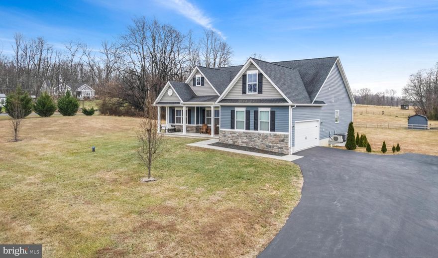 Just Listed!! Meticulously maintained 2017 Modern Contemporary 4 bed 3 bath 2-car side-load garage rancher offers an open floor plan in country location with a non-active HOA on over 3 acres! Over 2000 finished square feet featuring a fully equipped kitchen outfitted with granite countertops, an enormous center island with pendent lights, stainless steel appliances, double oven stove/range, subway tile backsplash, soft-close cabinet drawers, overlooking living/dining room combination w/ vaulted ceilings, ceiling fan, and pellet fireplace with stone backsplash. Off the dining room is access to the covered rear porch overlooking the backyard. This desirable split bedroom floorplan with the primary bedroom suite offering a tray ceiling, ceiling fan and walk-in closet overlooking the backyard. The owners bath comes complete with a garden tub, walk-in shower, tile floor, and dual sinks. A Junior suite w/ full bathroom is located above the garage, and two additional bedrooms w/ another full bathroom makes for the perfect layout. The common area is outfitted with durable LVP flooring. This home also comes complete with a full unfinished walk-out basement with rough-in for future bathroom.  Outside the basement doors sits a nice concrete slab that is prepared and ready for a hot tub. Less than 10 minutes from VA state line and downtown Charles Town, West Virginia. This is a must see to appreciate! Professional pictures coming soon.