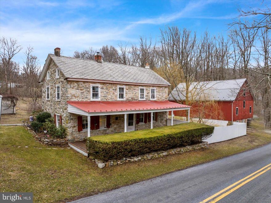 Nestled in the  countryside of Boyertown, PA, this charming, circa-1700s stone farmhouse blends historic character with modern comfort. Located in the Brandywine Heights School District, this 3-bedroom, 1.5-bath home sits on over 3.5 acres of partially wooded picturesque land, featuring lush fruit trees—including peaches, pears, and grapes.  Step inside to admire the exposed wood beams, an antique Prizer Painter coal stove, and a thoughtfully designed galley kitchen with double ovens. A first-floor bedroom offers convenience and flexibility. Outdoor living is just as inviting, with a large front porch, a spacious patio adorned with string lights, a fire pit, and a tranquil koi pond—perfect for entertaining or unwinding. The partially fenced property also includes a smoke house, two-story barn with electric, and three car garage with a second story workshop.  Ample storage in the full basement with cement floors. Experience the charm and timeless appeal of this one-of-a-kind farmhouse at 136 Landis Store Rd.—a perfect retreat with endless possibilities.