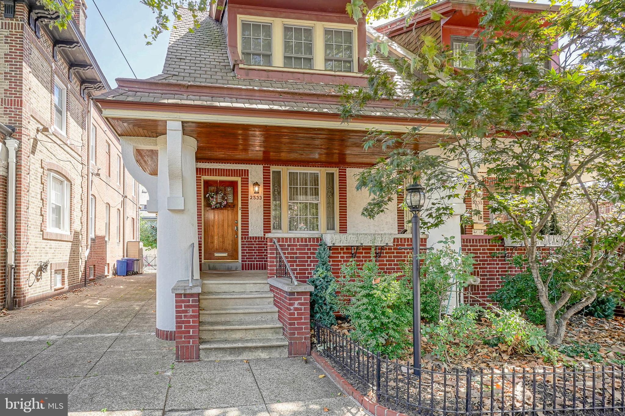 A beautifully maintained porch-front home located on a wide, tree-lined block in the heart of Girard Estates. Step inside to find hardwood flooring that flows seamlessly through the spacious living and dining areas, accented by elegant wainscoting, crown molding, and a custom marble fireplace that creates a warm focal point. The chef’s kitchen is a showstopper, featuring Thermador appliances, abundant storage, and custom finishes. Just off the kitchen, enjoy a sun-filled room with a convenient powder room, perfect for casual dining or relaxation. Upstairs, you’ll find three generously sized bedrooms with ample closet space and a fully tiled hall bath with a pedestal sink. The primary suite is a true retreat, offering its own private tiled bathroom with a jacuzzi tub, glass-enclosed shower, and a marble vanity. The fully finished basement expands the living space,complete with carpeting, an additional powder room, a built-in kitchenette with cabinets and a sink, a dedicated laundry room, and even a separate workshop area. Out back, the private yard offers both function and charm, with concrete space for lounging, colorful garden beds, mature trees, and a patio area ideal for entertaining. Located in one of South Philadelphia’s most desirable neighborhoods, this home is just minutes from local shopping centers, sporting complexes, major highways, and public transportation. Don’t miss the opportunity to make this stunning Girard Estates home your own!