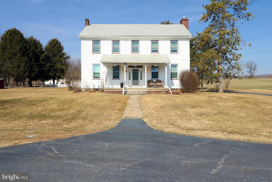 This picturesque 1800’s farmhouse, set on 10.88 scenic acres, offers both timeless appeal and practical amenities. Whether you’re drawn to its vintage character or envision creating your ideal countryside retreat, this property is full of potential. On the first floor you’ll find 10 foot ceilings, a spacious living room featuring hardwood floors and a stone fireplace and a full bathroom with a walk in shower. The classic and nicely updated, farmhouse kitchen has solid wood cabinets, a double oven, and plenty of natural light. Adjacent is an enclosed porch with lots of possibilities. Upstairs, you'll find the primary bedroom alongside three very generously sized additional bedrooms and a nicely updated full bath. The walkup attic offers lots of storage and potential to be transformed into additional living space. Outside you’ll enjoy a flat lot, in ground pool with newer liner and sweeping views of the surrounding countryside with lots of privacy. The property features a bank barn with a milk house and 2 additional large outbuildings including a shed with a wood furnace (piped to the main home). With Clean and Green tax benefits and horse-friendly zoning, the possibilities are endless—whether for gardening, recreation, or even a hobby farm. This property offers a unique opportunity to enjoy a timeless farmhouse with room to grow, dream, and make it your own.