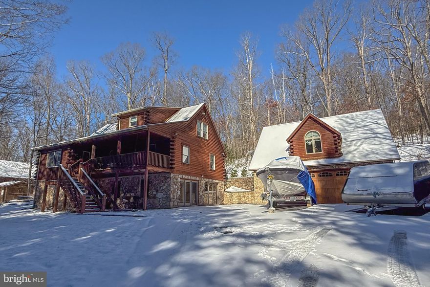 Beautifully crafted Log Home with oversized detached garage that has a spacious bonus room and bathroom above for added living space for guests and family.  This home in the coveted Sky Valley community has been thoughtfully renovated and upgraded with gorgeous stack stone and many, many extras.  This one is worth a look just to get a feel for how much room there is to entertain inside and out, how serene of a wooded lot it is, and Sky Valley has so many features such as lakeside area, walking trails, boat launch, dock area, picnic areas and more.
Enjoy outdoor lighting and surround sound, a pond area, covered front porch as well as a nice outdoor eating area.  The detached garage has been equipped with insta hot water for cleaning off any and all lake toys and so much storage area.  Are you in search of your lake home to enjoy all the beautiful seasons and all of the great activities for all ages - this one could be it! Being sold turnkey, furnished and ready to enjoy. Schedule your tour today!
