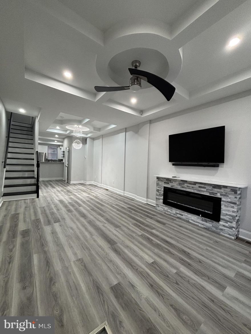 Prepare to be captivated by this absolutely stunning 3-bedroom, Den, 2.5  bath residence located in the sought-after Ellwood Park community. This home offers an unmatched combination of luxury modern updates, sophisticated design, and functional living space—all ready for you to move right in.
From the moment you cross the threshold, you'll be immersed in elegance. Enjoy the height of sophistication with custom tray ceilings found in the spacious living room, formal dining room, and the luxurious owner's suite.The living room features a cozy fireplace for relaxing evenings and is beautifully accented by a 3-foot crystal drop chandelier that sets a glamorous tone.The chef's dream kitchen boasts sleek granite counter tops and a full suite of stainless steel appliances, perfect for culinary creation and entertaining. Elegant, gleaming hardwood floors flow seamlessly throughout the entire home. The private Owner's Suite is a true retreat, featuring its own dedicated full en-suite bathroom. The main hall bathroom is designed for ultimate relaxation, complete with advanced spa shower settings. An extra den space provides the perfect flexible area for a home office, gym, or play area. The entire lower level is a fully finished basement, offering fantastic potential for additional living space, entertainment, or both! Laundry is made easy with the inclusion of a full-size washer and dryer. This location is an absolute dream for city living and commuters. Just minutes from Johns Hopkins Hospital and Medical Campus. Enjoy a seamless commute with the convenience of being steps away from Edison Highway. This gorgeous, luxuriously updated home simply won't last long!