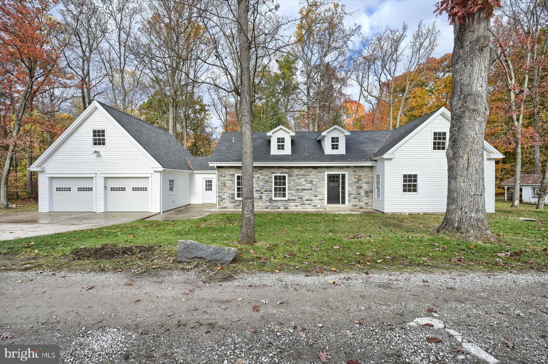 Come see this beautifully finished 4 bedroom, 3 ½ bath home set on one acre with a level yard on a low traffic dead end street minutes from 83. Halfway between York and Harrisburg. Home has just been completely redone inside and out! The first floor open floor plan offers plenty of living space with luxury vinyl plank flooring throughout. The kitchen highlights granite counters, white herringbone tile backsplash, soft close cabinets, stainless steel appliances and a kitchen island with seating area. Off of the main living area is the laundry, a half bath and mudroom with access to the garage and deck. You have your pick of owners suites with one on each floor! The spacious first floor owners suite highlights walk in closets and a stunning bath with double bowl vanity and walk in shower with pebbled stone floor. The upstairs has the second owners suite with bath and an additional two bedrooms and a full bath. Also boasting pella windows plus an extremely efficient new heat pump. Oversize garage plus a bonus room ready to be finished to fit your family’s needs and two additional outbuildings, great for autos, storage, workshop etc. Relax on one of two private decks and enjoy the view of the stream and woods. Act now or miss out!