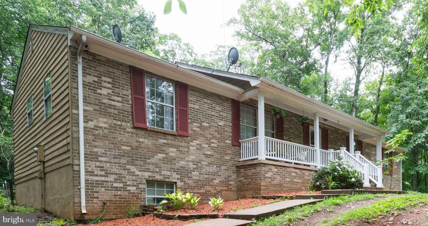 Beautiful Large Brick Rambler on wooded 1.7 acres in a rural setting - has internet and cell repeater, equipment to stay with the house.   Home welcomes you with a large unique kitchen with fresh paint, that features an island, stainless steel appliances, table space, and pellet stove - a great place for gathering around the kitchen table. There is also a separate Dining Room and Large Living Room, and Three generously sized bedrooms on the main floor, including the Primary Bedroom and Bath.  Out of the sliding glass door in the kitchen is a large deck and fully fenced back yard.   New carpet throughout, including the lower level. Speaking of the lower level, it is a walk-out with an ample family room and office/possible guest bedroom. Septic inspection was done and repairs made with receipts available.  Make this your new home!