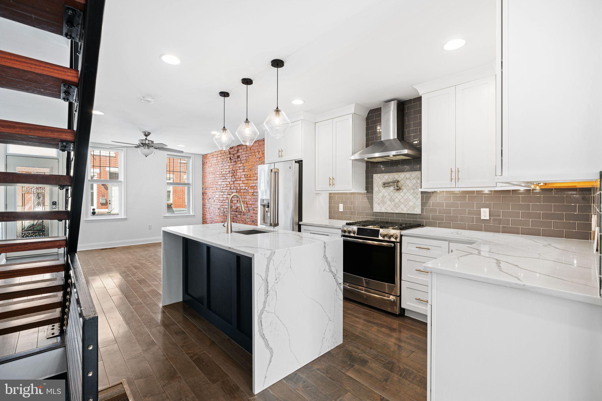 Even though it may look like it, this isn't a HGTV home! The only way to describe this fully rehabbed South Philly gem is modern custom! First thing you'll notice when entering is the spacious open floor plan which flows right into the GORGEOUS eat-in kitchen fully equipped with Calcutta quartz countertops, infinity island, glass subway tile backsplash with a marble in-lay, custom white shaker cabinets, and cant forget about forgot the GE Café appliances and the half bath right off the back of the dining room! Bella hardwoods run throughout the main floor and upstairs right into the bathrooms of all bathrooms! Custom glass shower fully equipped with an onyx shower pan, along with the custom quartz double vanity and the massive soaking tub, this bathroom just continues the beautiful custom touches that run throughout this home. Did I mention the 9 1/2 foot ceilings in the primary suite? This home has it all, do not miss out!!!