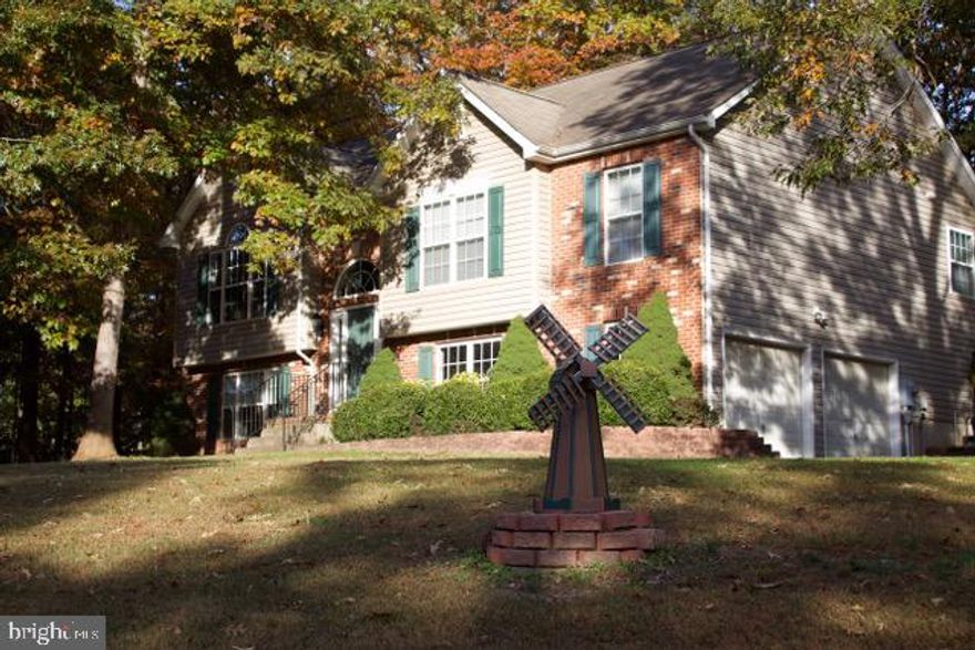 This beautiful 4-bedroom home is like living in a park - 1 ACRE partially wooded lot with beautiful landscaping and a multi-tiered outdoor deck perfect for entertaining. The home boasts an open floor plan with a large bright eat-in kitchen and separate spacious dining room. New laminate flooring and fresh paint throughout the home with brand new stainless steel appliances, large sink and quartz counters. Home also has a new HVAC system and well pump. Situated in a quiet well taken care of neighborhood with no HOA! Home has its own private well and septic systems.  Additional features include a large 2-car garage with ample storage space, extra-wide driveway and Invisible Fence (special fence area for dog), close to MCB Quantico, I95, I66, Stafford Market Place, Potomac Mills, and Fredericksburg. Situated in the Mountain View High school district. Welcome home!