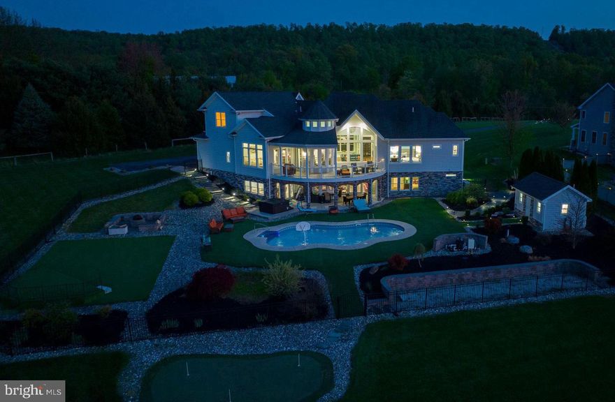 Wow what a view from this 5,000 + sqft property situated on 3 acres overlooking the river and Harrisburg! Custom built home featuring an inground swimming pool with a pool house, outdoor stage area, putting green, and more! Feel like you are on vacation all year round! This beautiful home offers a bright and open layout with modern, luxurious - custom fixtures throughout. The gourmet kitchen offers high-end appliances and countertops. A breakfast area offers panoramic views. The kitchen opens to a family room with exposed wooden beams. First floor master suite includes a luxurious en-suite with a jacuzzi tub in the center, dual vanities, and a tiled walk-in shower with multiple rainfall shower heads. Enjoy the wonderful views in every room on the main level. The lower level offers a unique one-of-a-kind entertainment experience. Featuring an open area for entertaining/gathering, a center stage, custom wall art by local artist, full bar. A guest bedroom with private bath is also located on this level. The upper level offers a rec room, two additional bedrooms, and full bath.  Energy efficient home with solar panels and a back up generator. This home offers a total of 4 bedrooms, 3 full baths, and 2 half baths. This is truly a once and a lifetime opportunity to own this custom home designed for indoor and outdoor entertaining with one-of- a kind views.