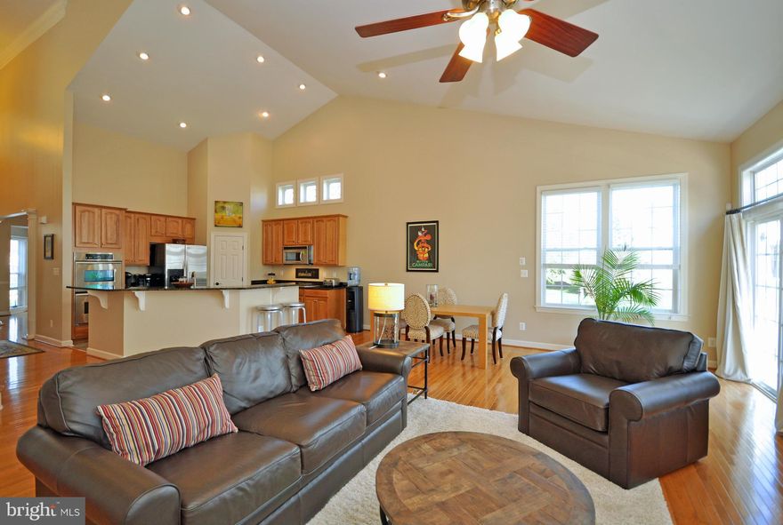 Absolutely pristine home where Life Imitates Vacation. Inside & out, there is everything to love here! Soaring ceilings w/tray detailing & beautiful trimwork top a desirable open floor plan that is ideal for entertaining. Living space extends seamlessly to a stunning recent deck & patio, backing to trees. Community offers low-maintenance, resort living w/golf, pools, tennis, clubhouse & more.