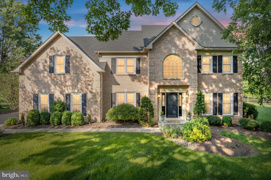 Welcome to 6 Windrose Circle, a stunning fully updated 5-bed, 2.1-bath home tucked away on a quiet cul-de-sac in the highly desirable Doylestown Lea neighborhood and just steps from the scenic Neshaminy Greenway Trail. Situated on over half an acre, this meticulously maintained property offers style, comfort, and functionality in one of Doylestown's most popular neighborhoods. A bluestone paver walkway welcomes you to the front entrance and into the impressive foyer, illuminated by a gorgeous porcelain chandelier. To the right, a spacious formal sitting room opens via French doors to a warm and inviting family room featuring a gas fireplace and oversized sliding glass doors that lead to a spacious paver patio—ideal for entertaining. To the left of the foyer, the formal dining room flows seamlessly into the fully renovated kitchen, with a convenient butler’s pantry in between. The kitchen is a chef’s dream, boasting custom two-tone cabinetry, granite countertops, additional cabinetry with built-in wine fridge, and custom blinds. Rich hardwood floors and beautiful crown moulding run throughout the home, complementing the refined finishes. The grand staircase leads to five oversized bedrooms, including a luxurious primary suite with two, large walk-in closets, and a spa-like bath featuring a stand-alone soaking tub, frameless glass shower, dual vanities and custom cabinetry. A completely renovated hall bath with designer tile flooring, contemporary lighting, large tub/shower and dual vanities with quartz countertops offer added convenience with every detail thoughtfully upgraded to combine comfort and style. The impressive finished basement provides multiple flexible spaces perfect for a home gym, office, playroom, or media area with ample storage space offered in the unfinished section. A large laundry/mudroom room on the main floor includes new washer/dryer units and built-in cabinetry for ultimate organization. A patio door from the mudroom leads you to a stunning paver patio that spans the entire back of the home and is surrounded by lush landscaping and wired for surround sound. The expansive side yard is ready for a pool or hot tub, with a 220V hookup already in place. Additional updates include a newer roof, windows, HVAC system, hot water heater, water softener, resurfaced driveway and wiring for a garage generator. This home has been meticulously cared for and is truly move-in ready! Located just a short walk to Central Park, scenic trails, Terrain at DelVal, and the soon-to-be-completed Doylestown Township Park Improvement Project, 6 Windrose Circle offers unparalleled access to comfort and convenience. Don't miss your opportunity to own this exceptional home in one of Doylestown's most popular communities!